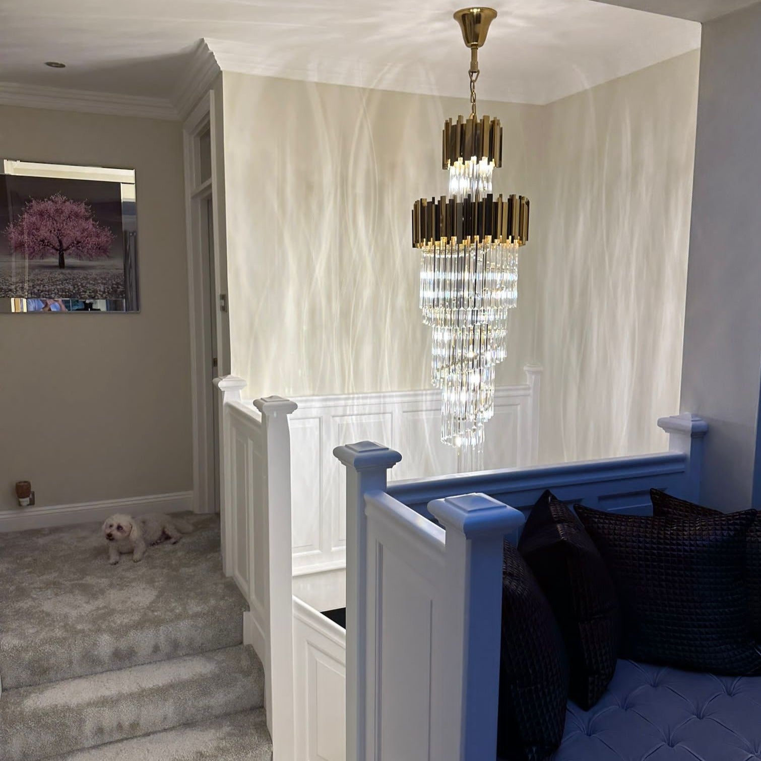 Side angle of the Boeotia Spiral Staircase Chandelier II in a bright hallway setting, showing its layered spiral tiers.