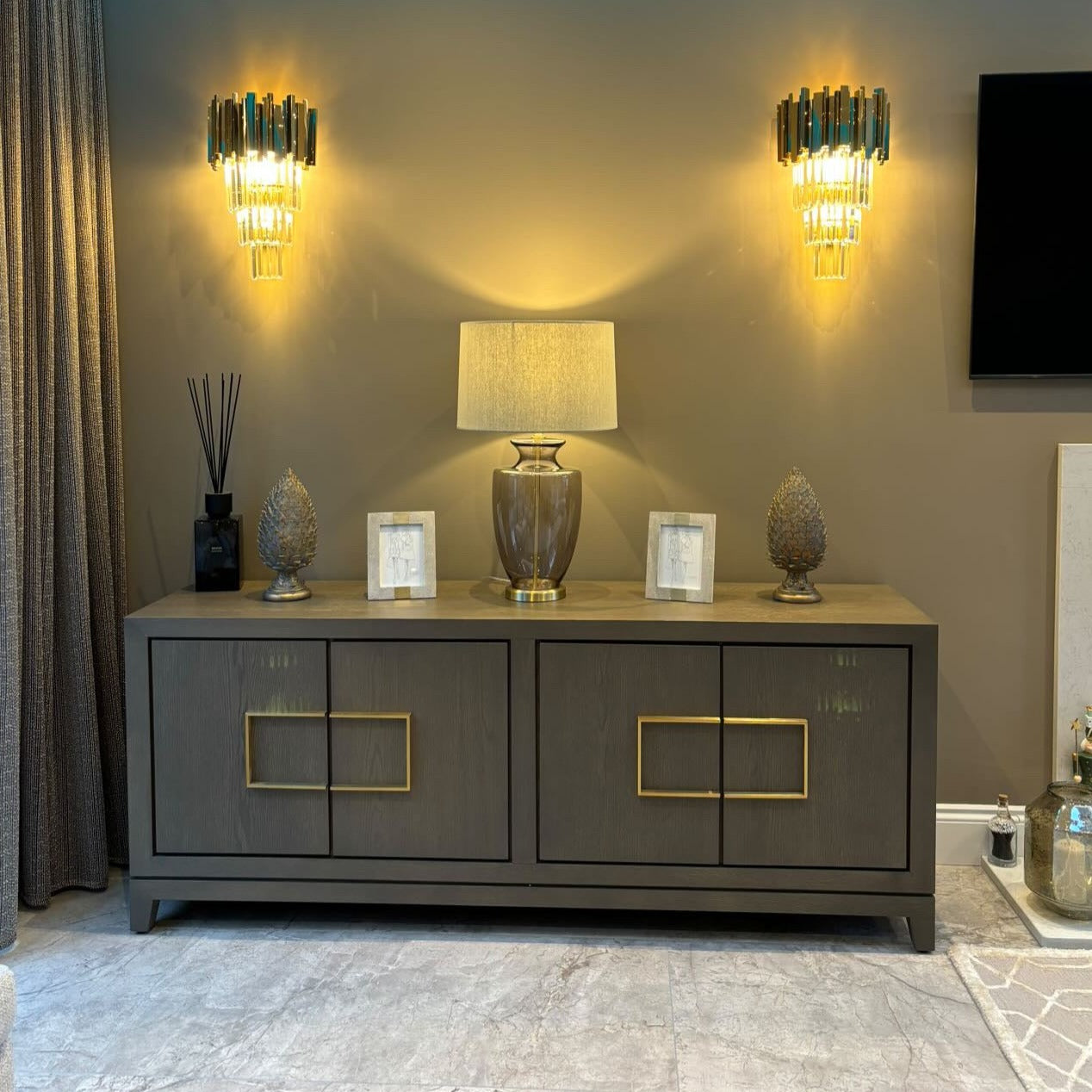 Boeotia Wall Light displayed in a luxury bedroom, creating a warm ambient glow with its crystal and gold elements.