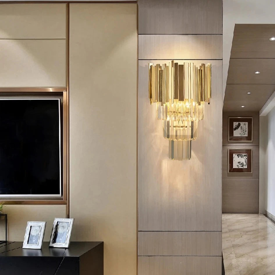 Boeotia Wall Light installed in a luxury hallway, featuring gold cuboid tubing and shimmering crystal bars.