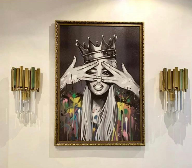 Pair of Boeotia Wall Light II fixtures displayed beside artwork, illuminating the space with a warm, elegant glow.