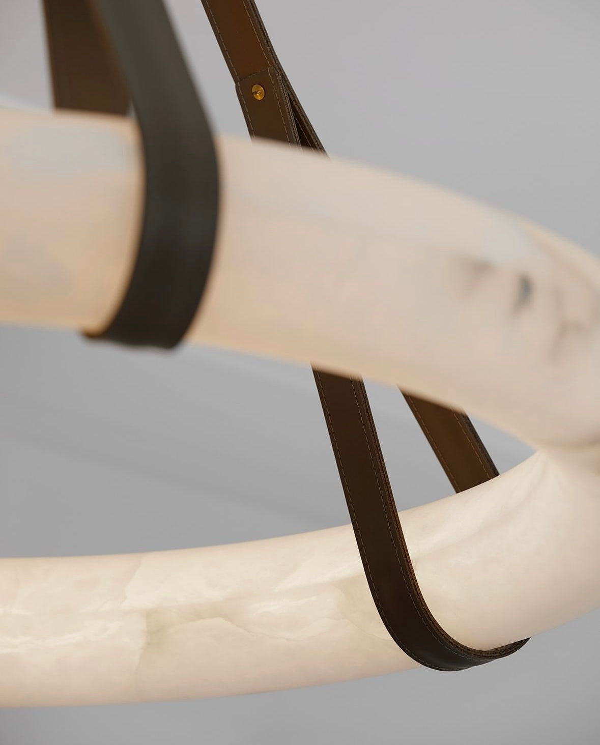 Angled view of the Botticino Marble Circular Chandelier highlighting the sculptural marble ring design.