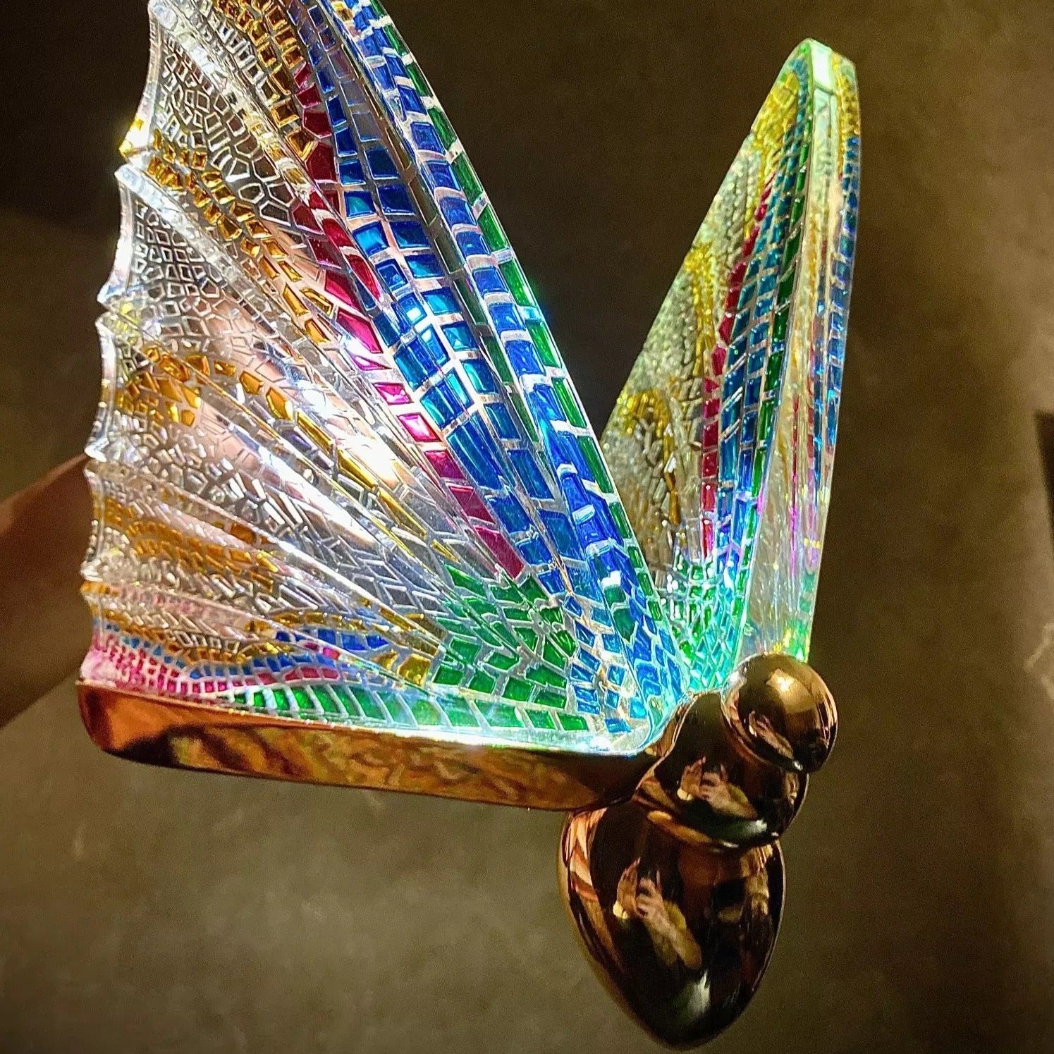 Butterfly Pendant Light with gold mounting and textured glass butterfly wings, emphasising its sculptural craftsmanship.