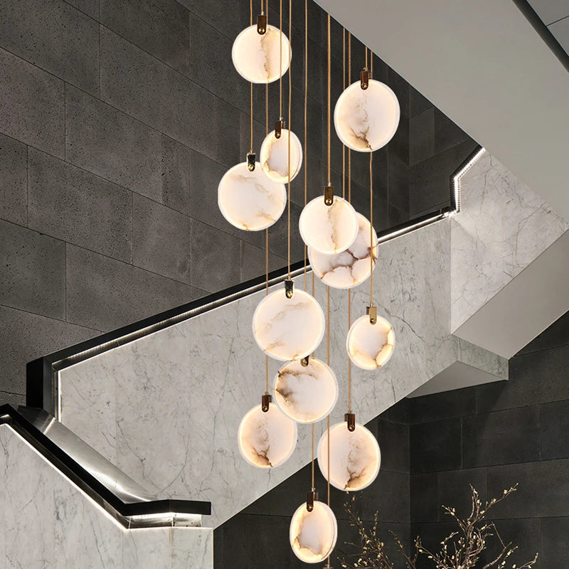 Calacatta Marble Pendant Staircase Chandelier featuring cascading marble discs suspended over a grand staircase.