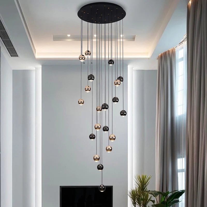 Vertical view of the Carlito Staircase Chandelier showcasing suspended modern spheres in a contemporary foyer.