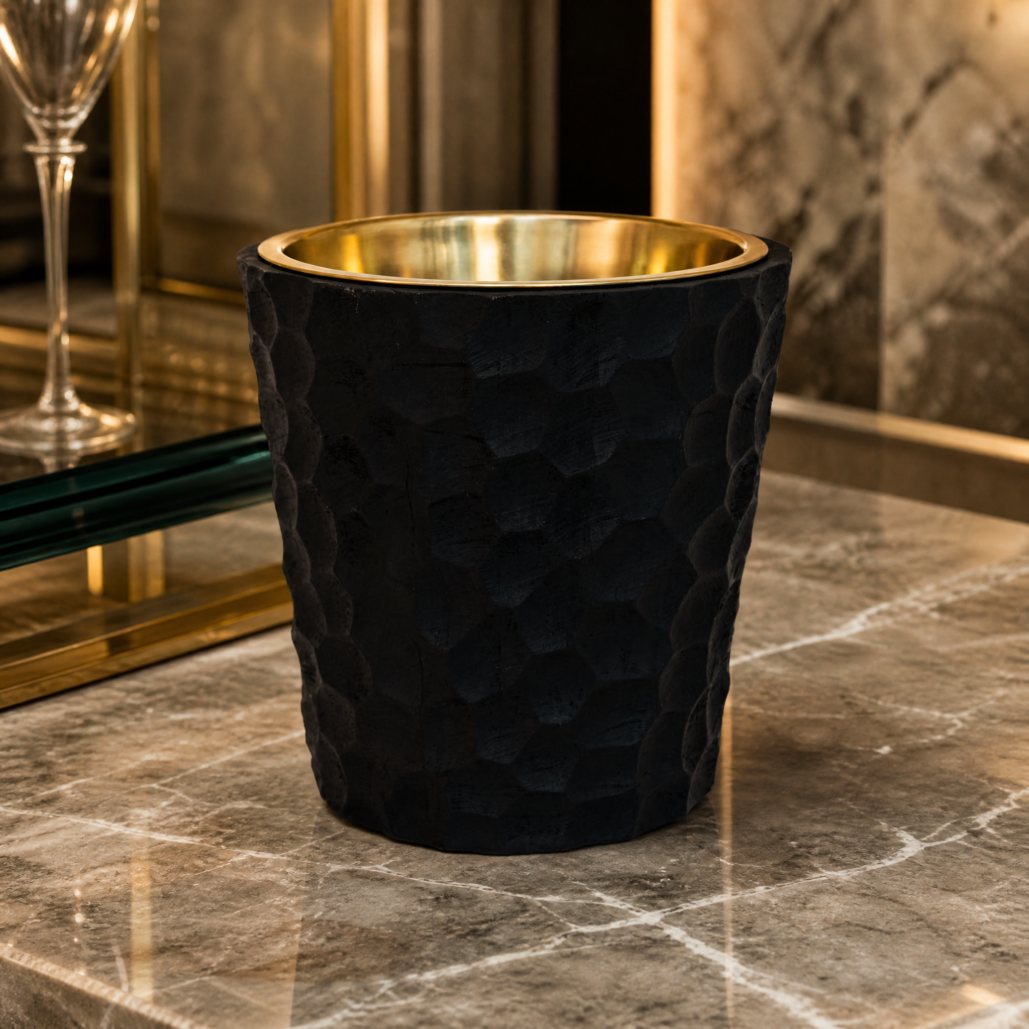 A detailed closeup of the VORELLI Castelli Wine Cooler, highlighting the rich contrast between the antique brass interior and the textured black wood finish.