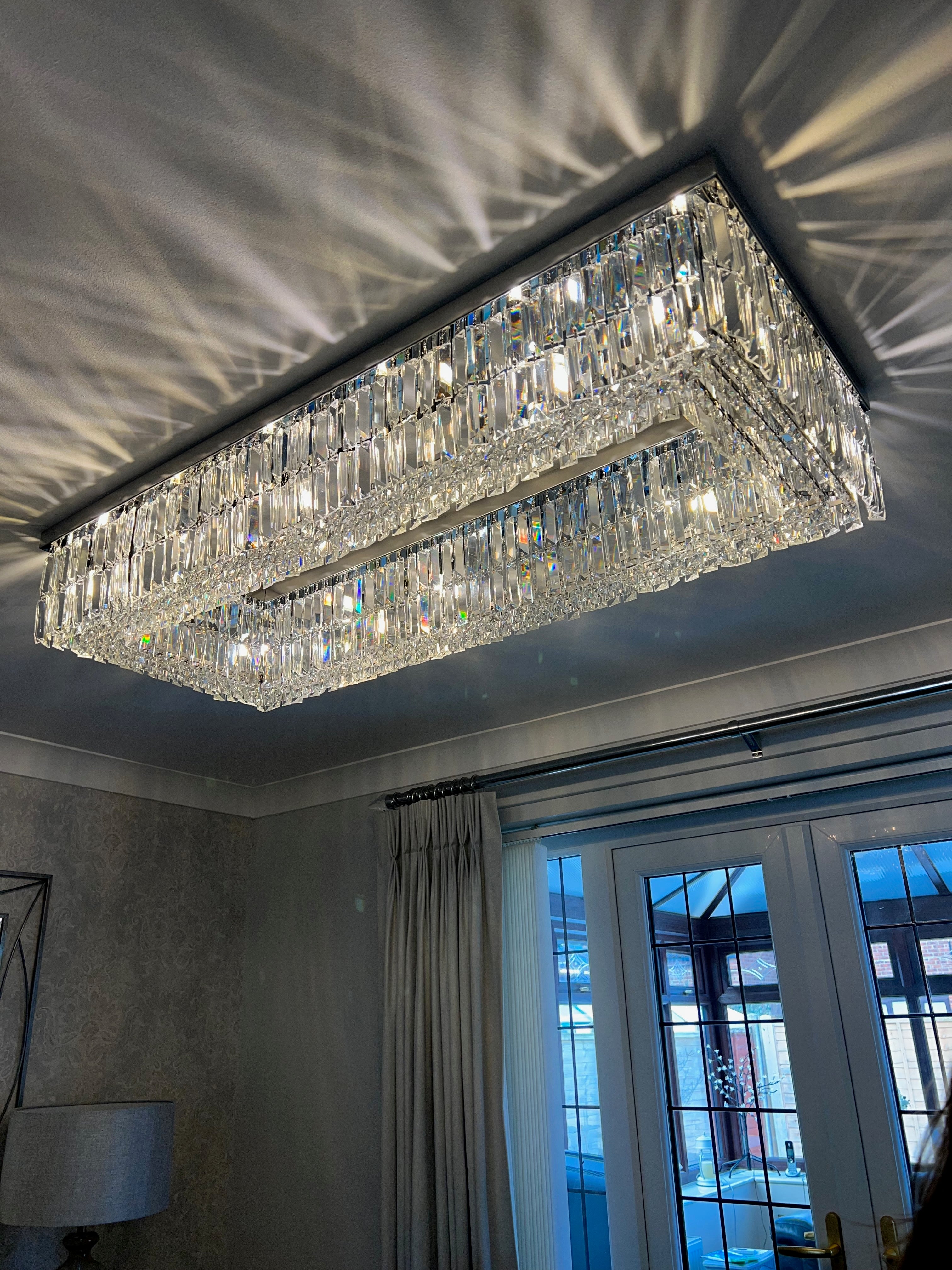 Angled view of a rectangular crystal ceiling light showcasing depth and layered crystal design