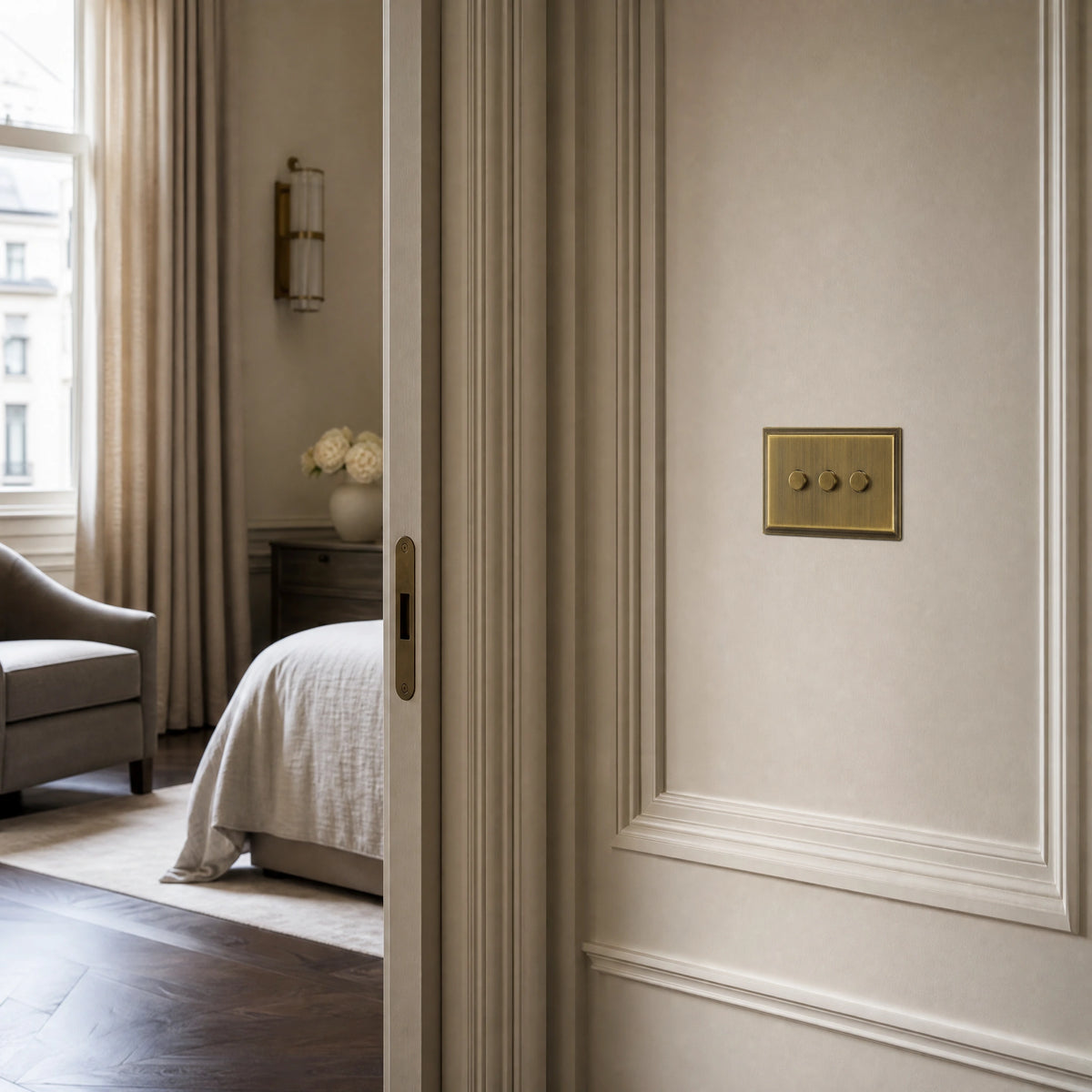 Luxury antique brass dimmer switch installed within feature wall beside an elegant doorway in a Belgravia-style residence in a UHNW interior by VORELLI®.