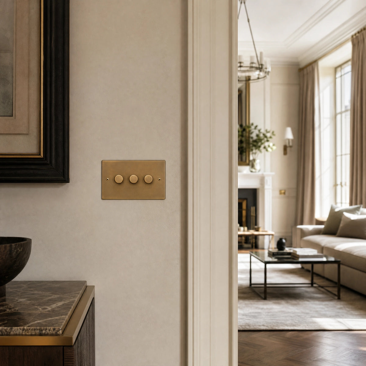 Luxury antique brass dimmer switch installed within feature wall beside an elegant doorway in a Belgravia-style residence in a UHNW interior by VORELLI®.