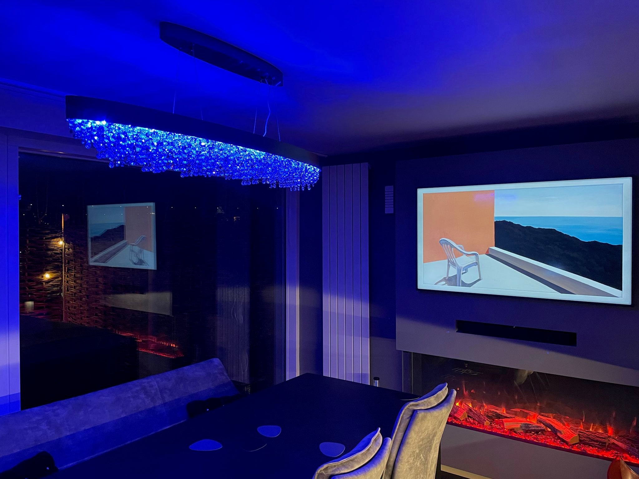 Blue RGB crystal lighting from the VORELLI® Donatello rectangular chandelier in a modern interior