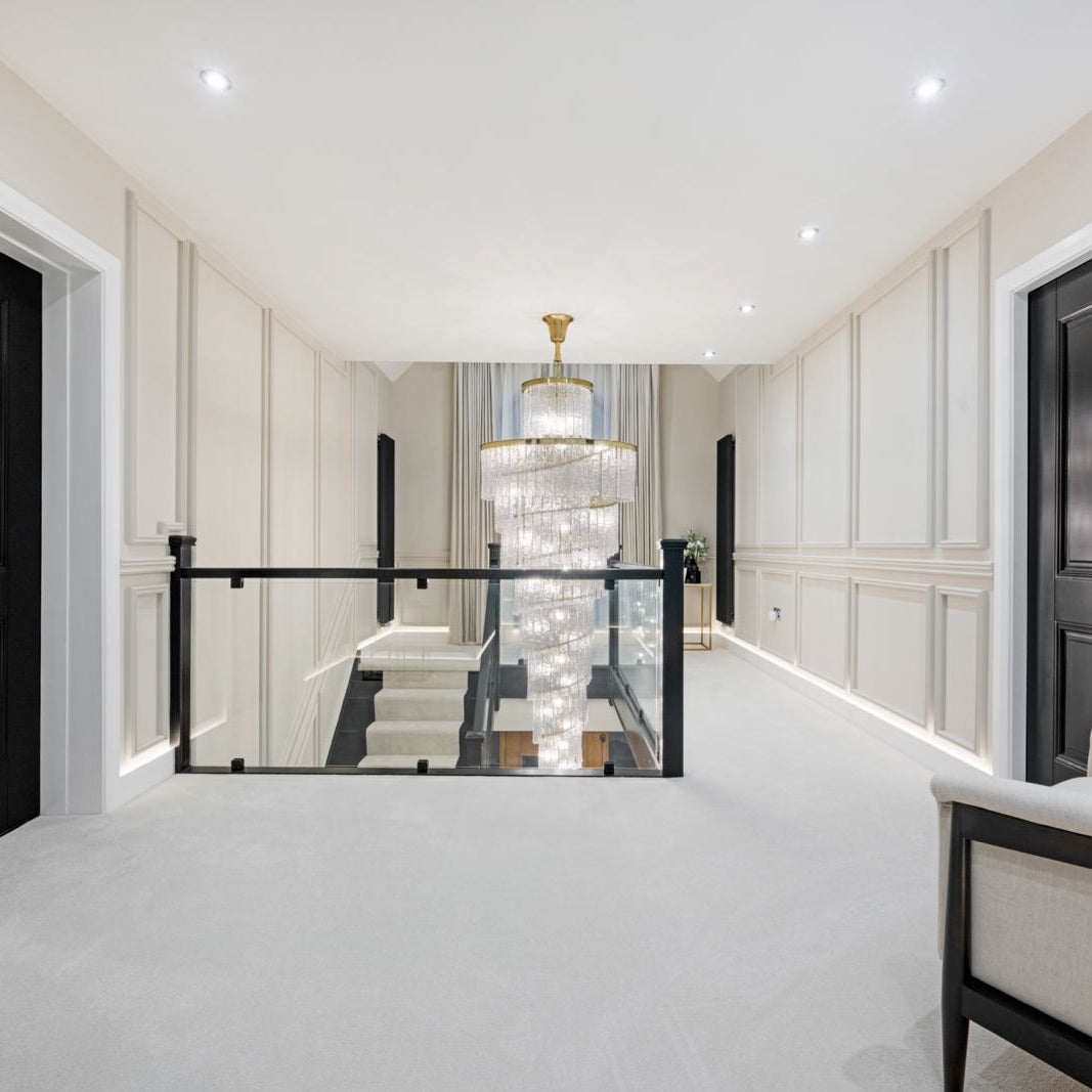 Luxury staircase chandelier illuminating a modern interior landing