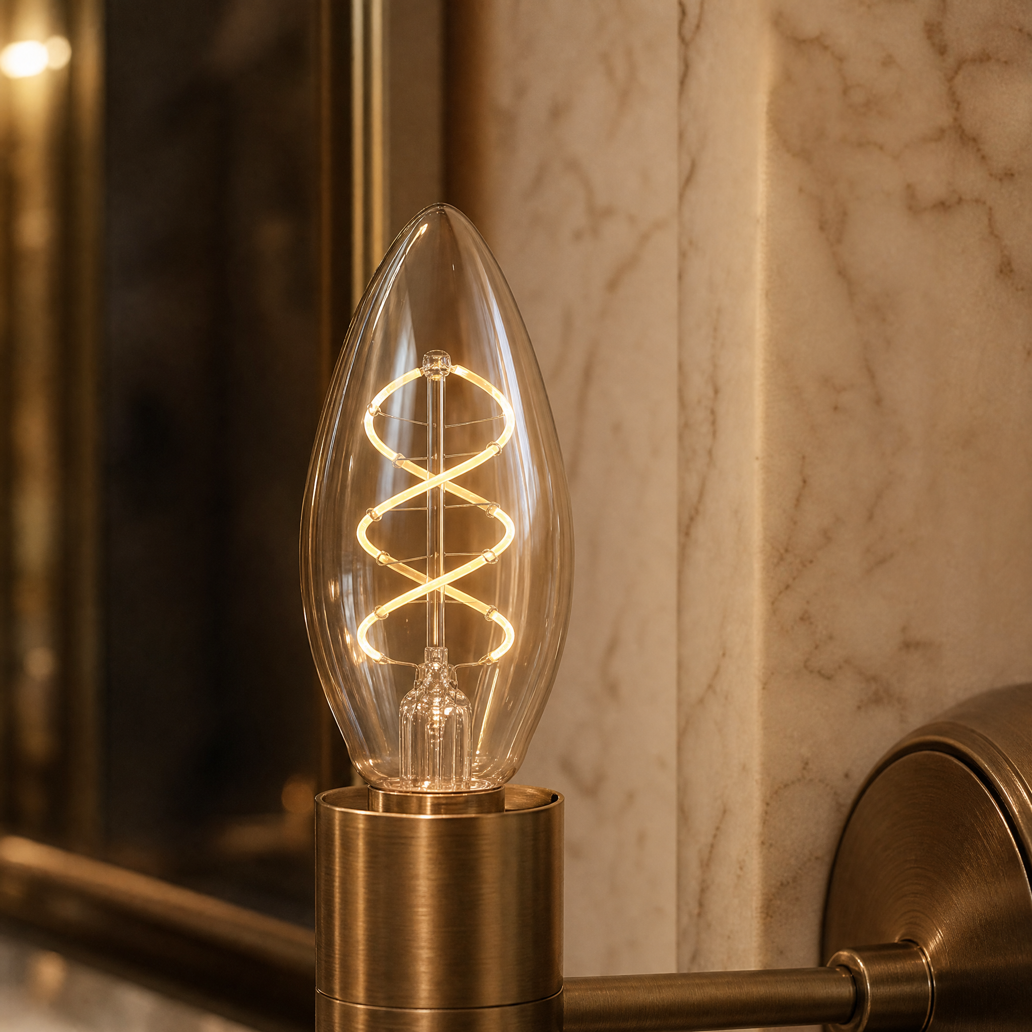 Close-up macro shot of the VORELLI E14 LED dimmable bulb showcasing the intricate spiral filament design and antique-bronzed coloured glass.