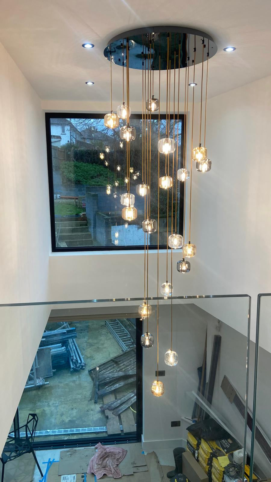 Luxury glass cluster pendant staircase chandelier in modern double height stairwell by VORELLI®