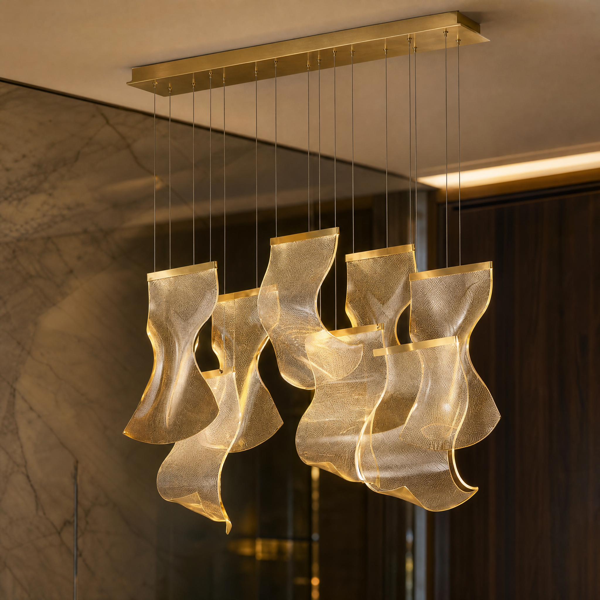 A detailed closeup of the VORELLI Fluente chandelier highlighting the flowing acrylic pendants and innovative LED technology.