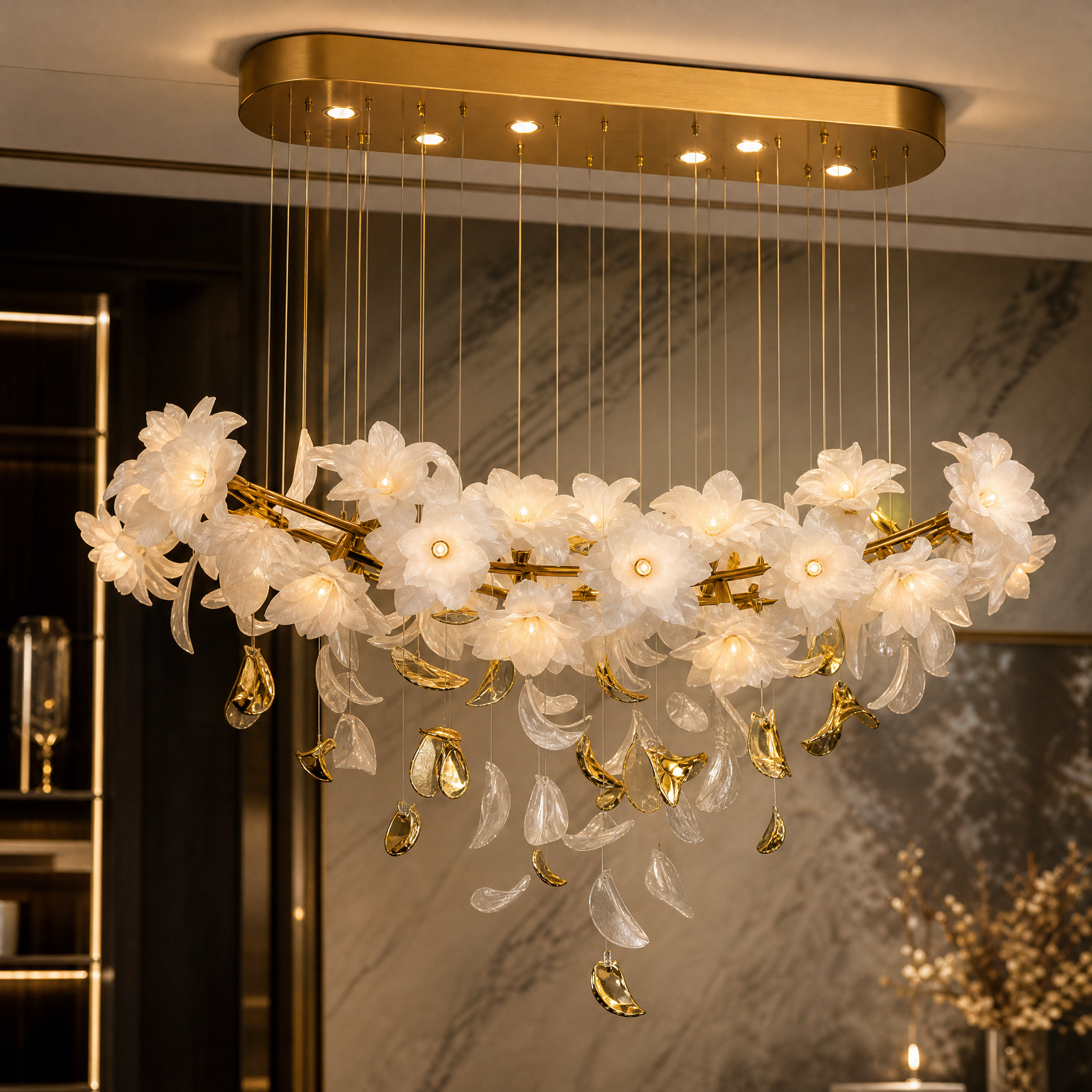 Detailed closeup of the illuminated floral glass blooms and cascading leaves on the VORELLI Gardenia Rectangular Chandelier II.