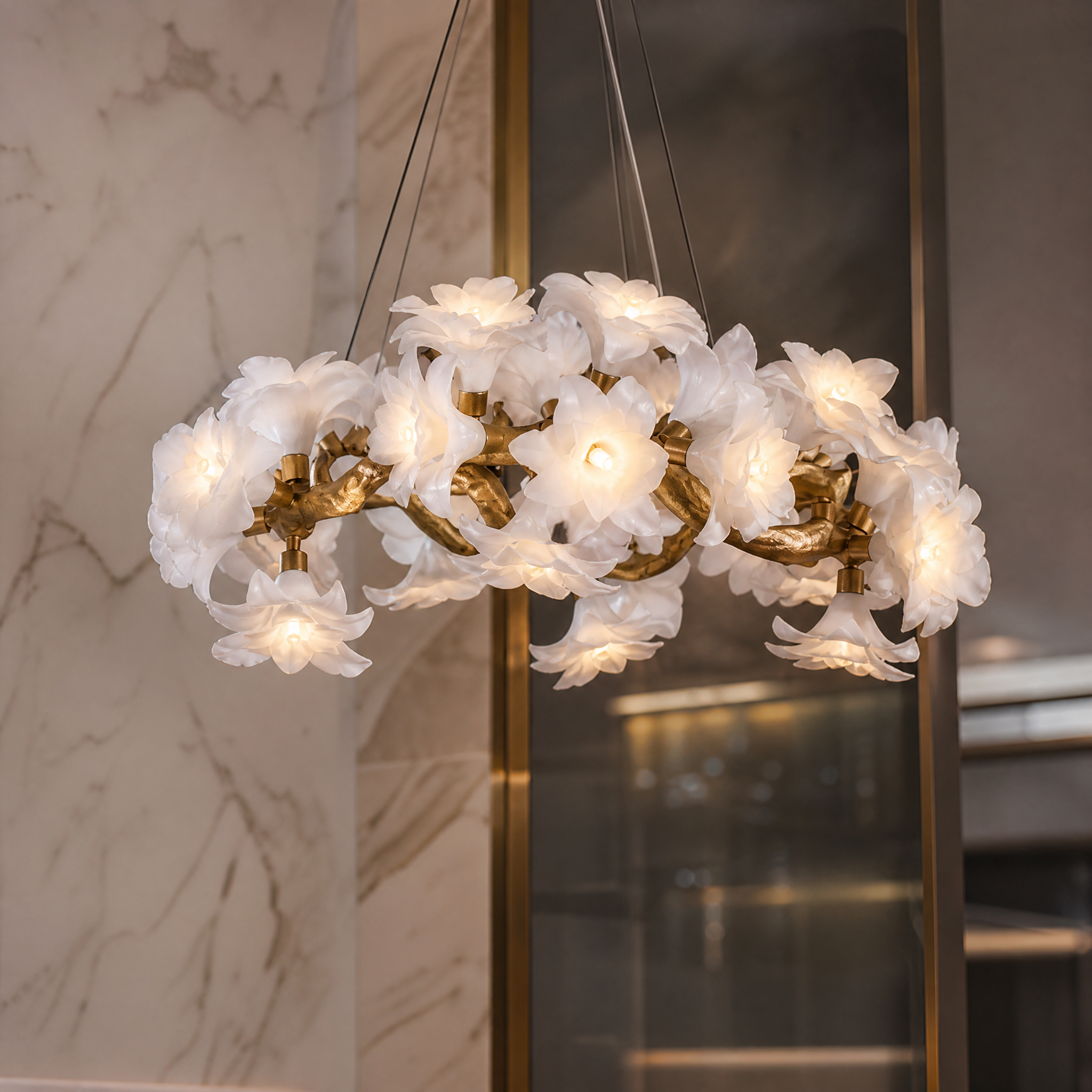 Detailed macro shot of the VORELLI Gardenia chandelier, showcasing the intricate sculptural floral glass elements and organic branch structure.