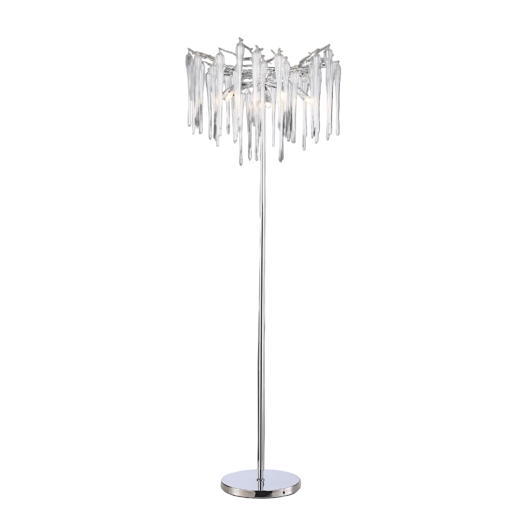 Vorelli Icicle floor lamp illuminated, showcasing the interplay of light and shadow through its sculptural glass silhouette.