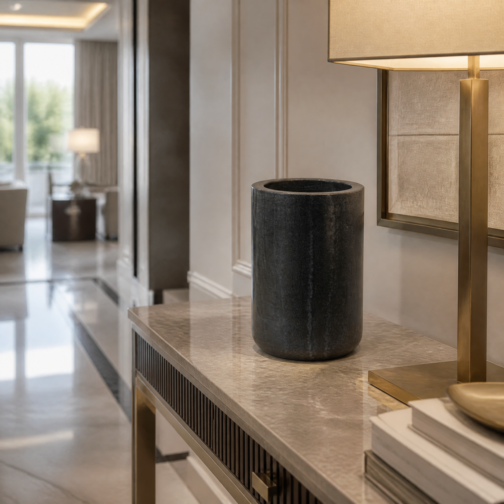 Vorelli Lunetta black marble vase displayed on a sleek console table in a luxury modern living room.