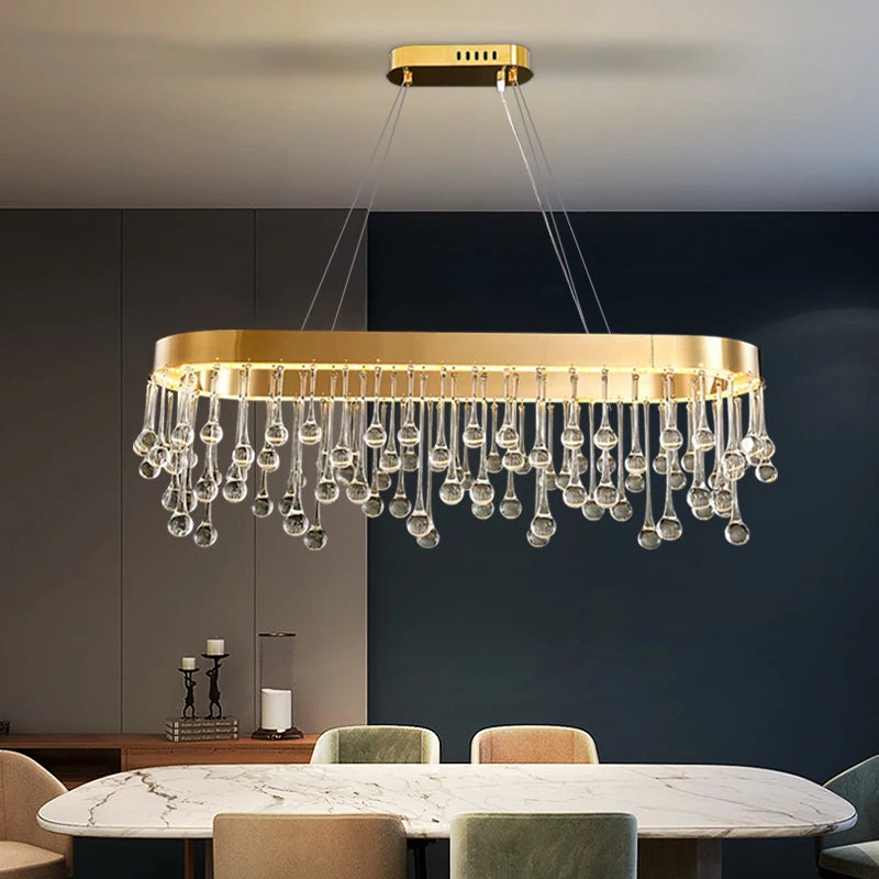 VORELLI Mancini rectangular chandelier with hanging crystal droplet detailing above a dining table