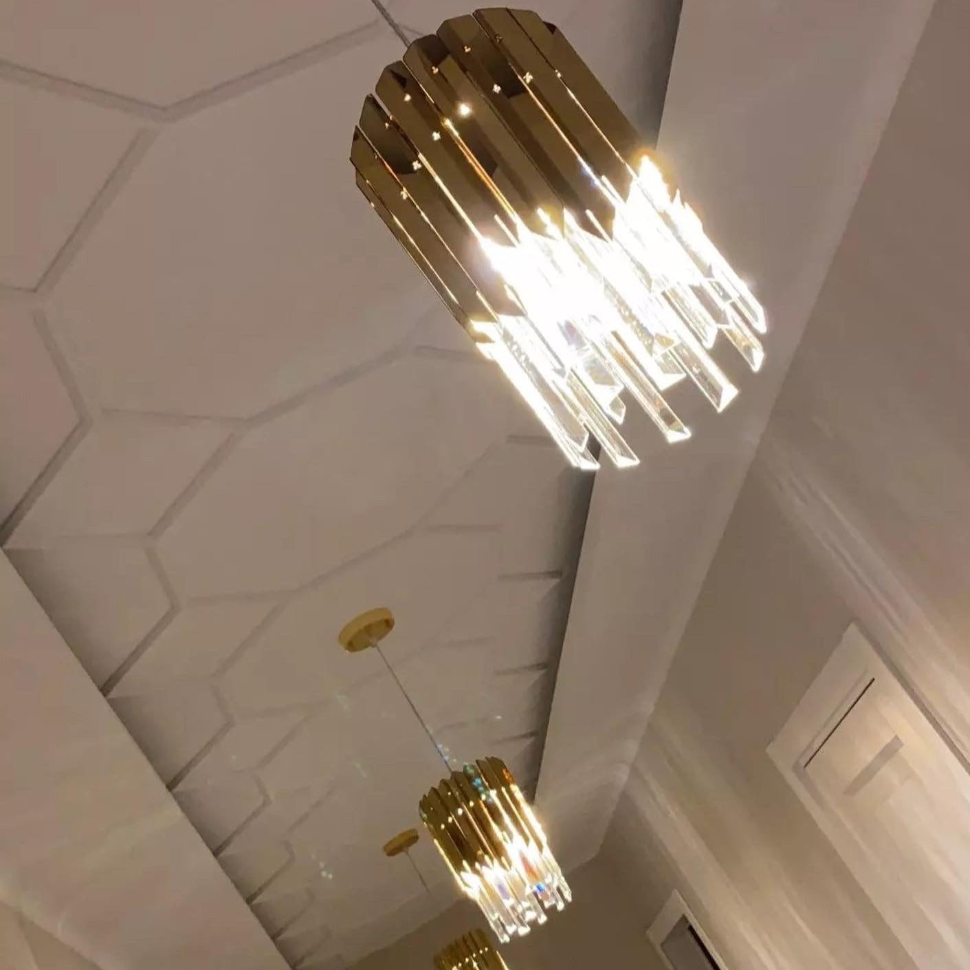 Upward view of VORELLI Manhattan Pendant showing suspended crystal bars and warm illumination