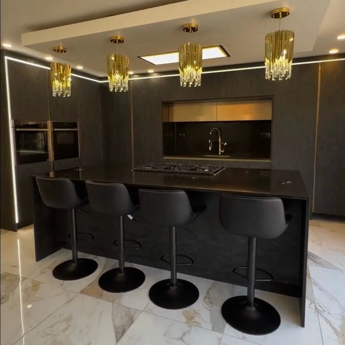 VORELLI Manhattan Pendant enhancing a sophisticated dark kitchen interior with glowing crystal bars