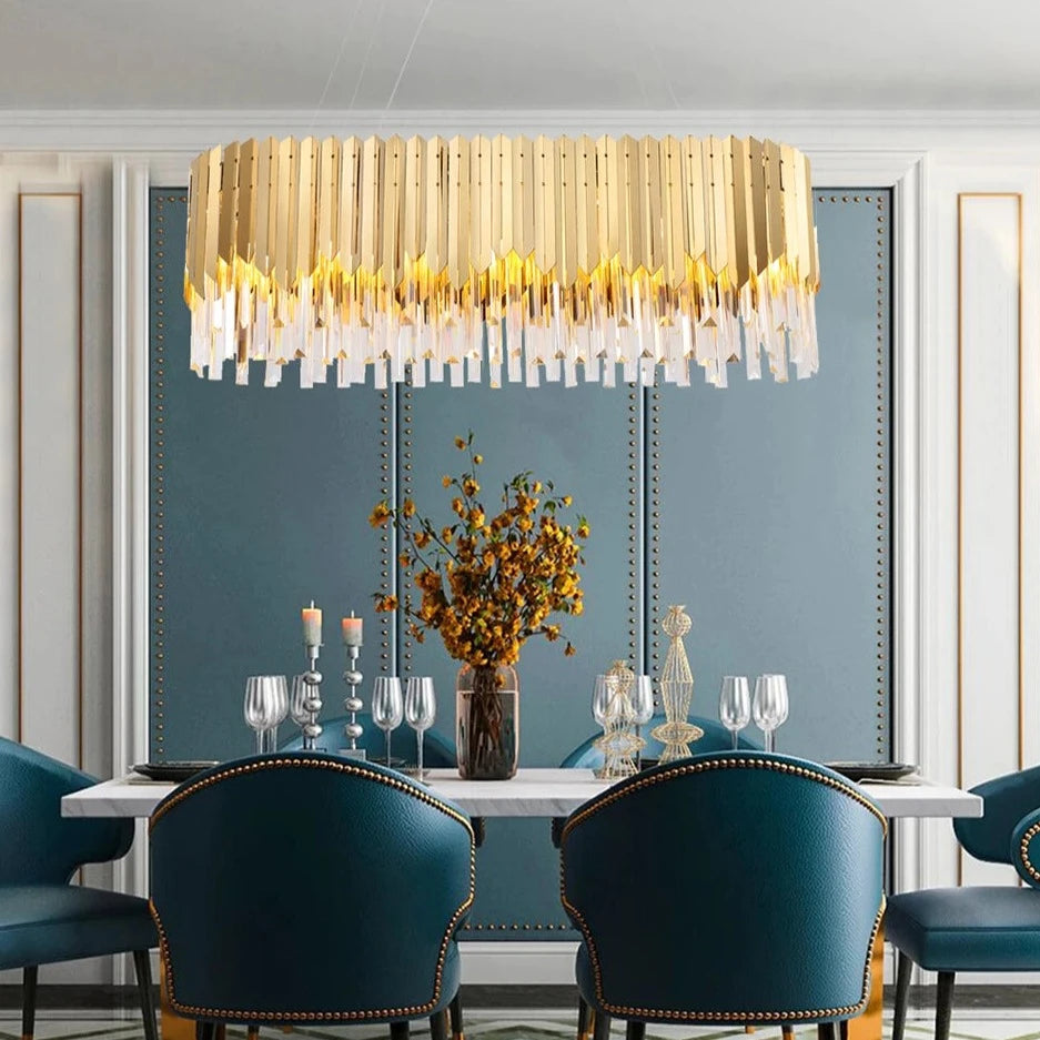VORELLI Manhattan Rectangular Chandelier creating a bold focal point above a formal dining table with blue velvet chairs