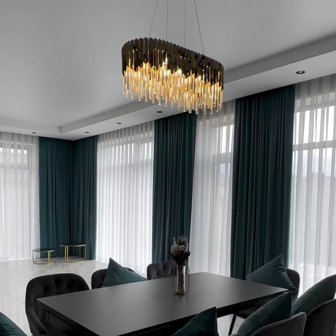 Modern dining room featuring the VORELLI Manhattan Rectangular Chandelier with warm glowing crystal bars