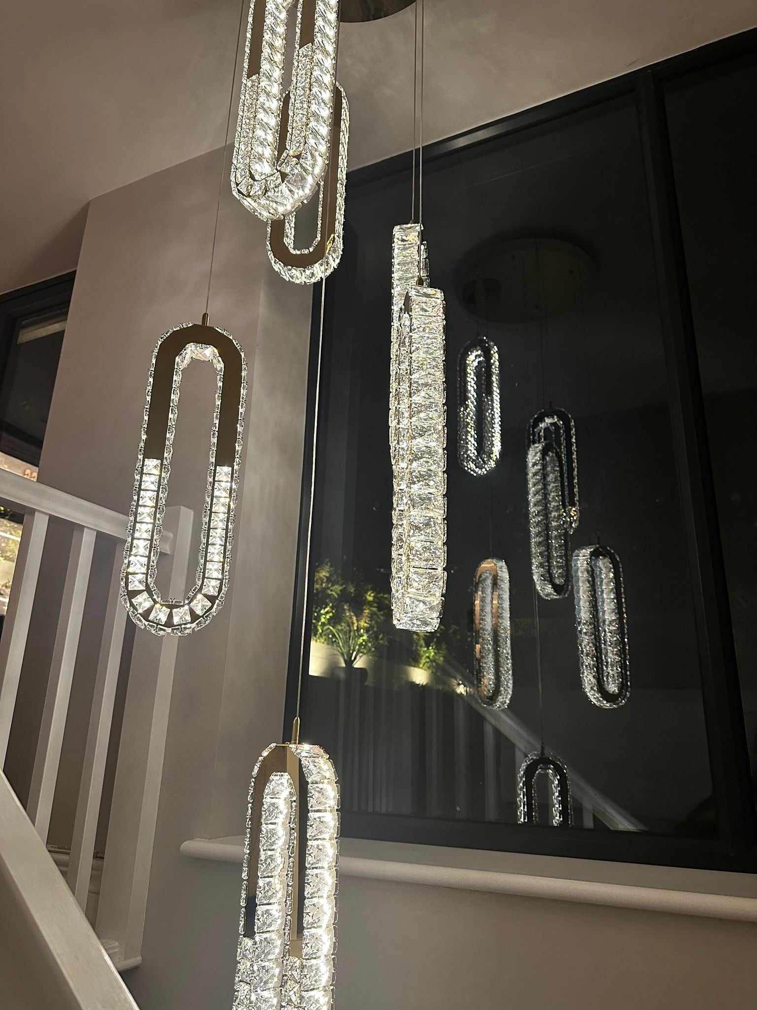 Close view of VORELLI Manzoni crystal pendant cluster forming a statement stairwell chandelier