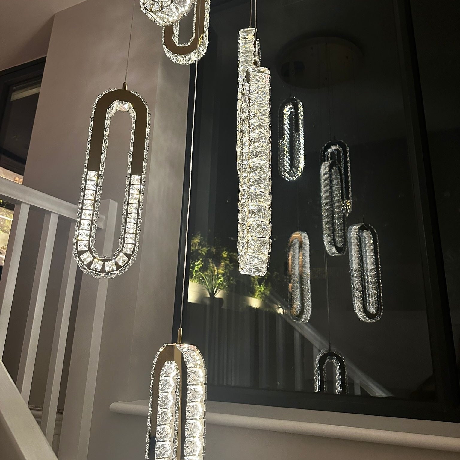 Close view of VORELLI Manzoni crystal pendant cluster forming a statement stairwell chandelier