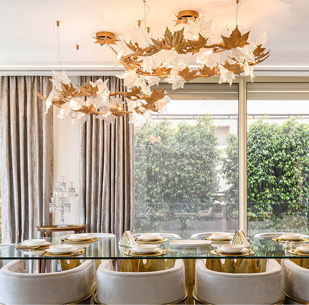 Luxury circular chandelier styled above dining table in modern interior