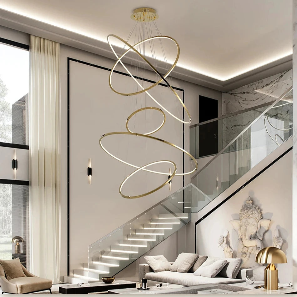 VORELLI Marcello ring staircase chandelier with multiple floating LED rings arranged in a spiral above a luxury modern staircase