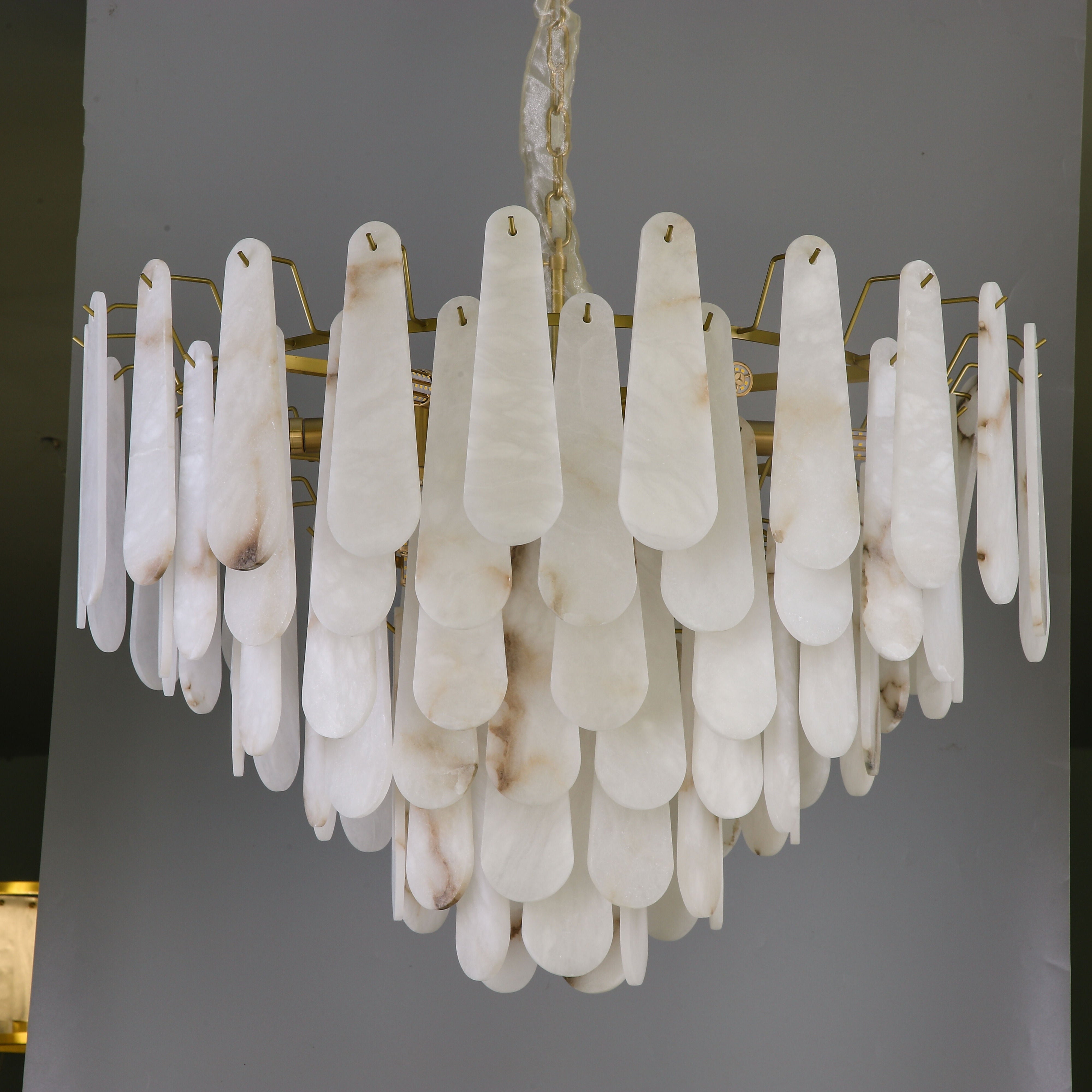 VORELLI Maretto marble circular chandelier suspended in a luxury interior creating an elegant focal point
