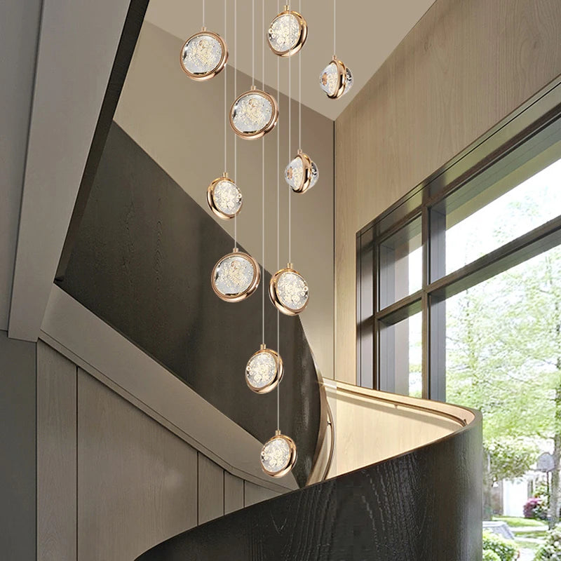 Modern VORELLI® staircase lighting featuring cascading illuminated pendants designed for double height spaces and luxury homes