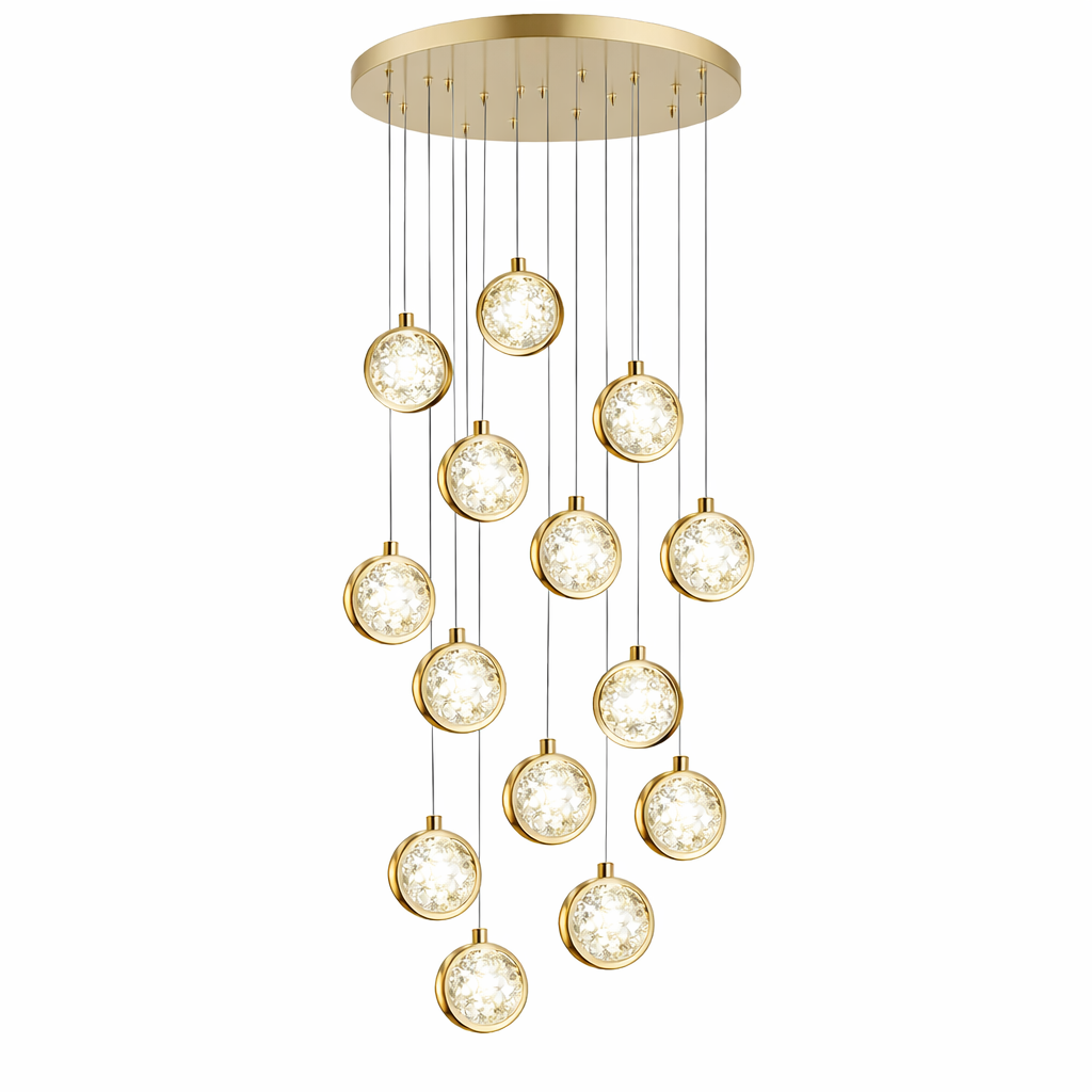 VORELLI Marlow pendant staircase chandelier casting a sophisticated light pattern across a modern open-plan living space.
