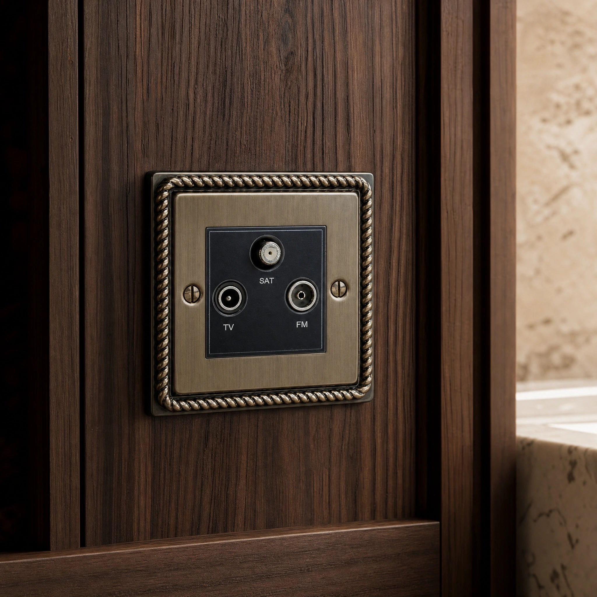 Close-up of a luxury antique brass media outlet installed within bespoke media wall or integrated TV joinery in a private residence by VORELLI®.