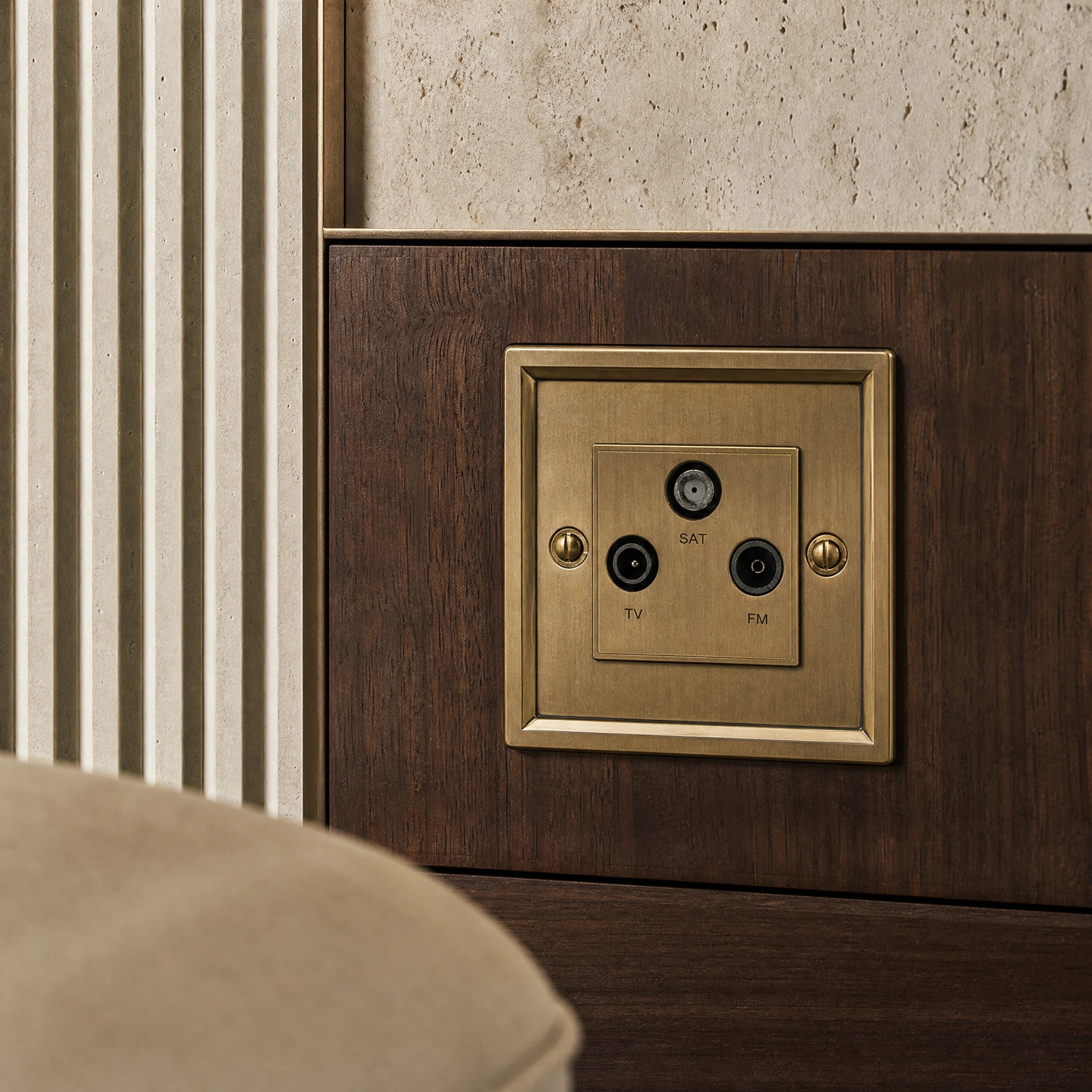 Close-up of a luxury antique brass media outlet installed within bespoke media wall or integrated TV joinery in a private residence by VORELLI®.