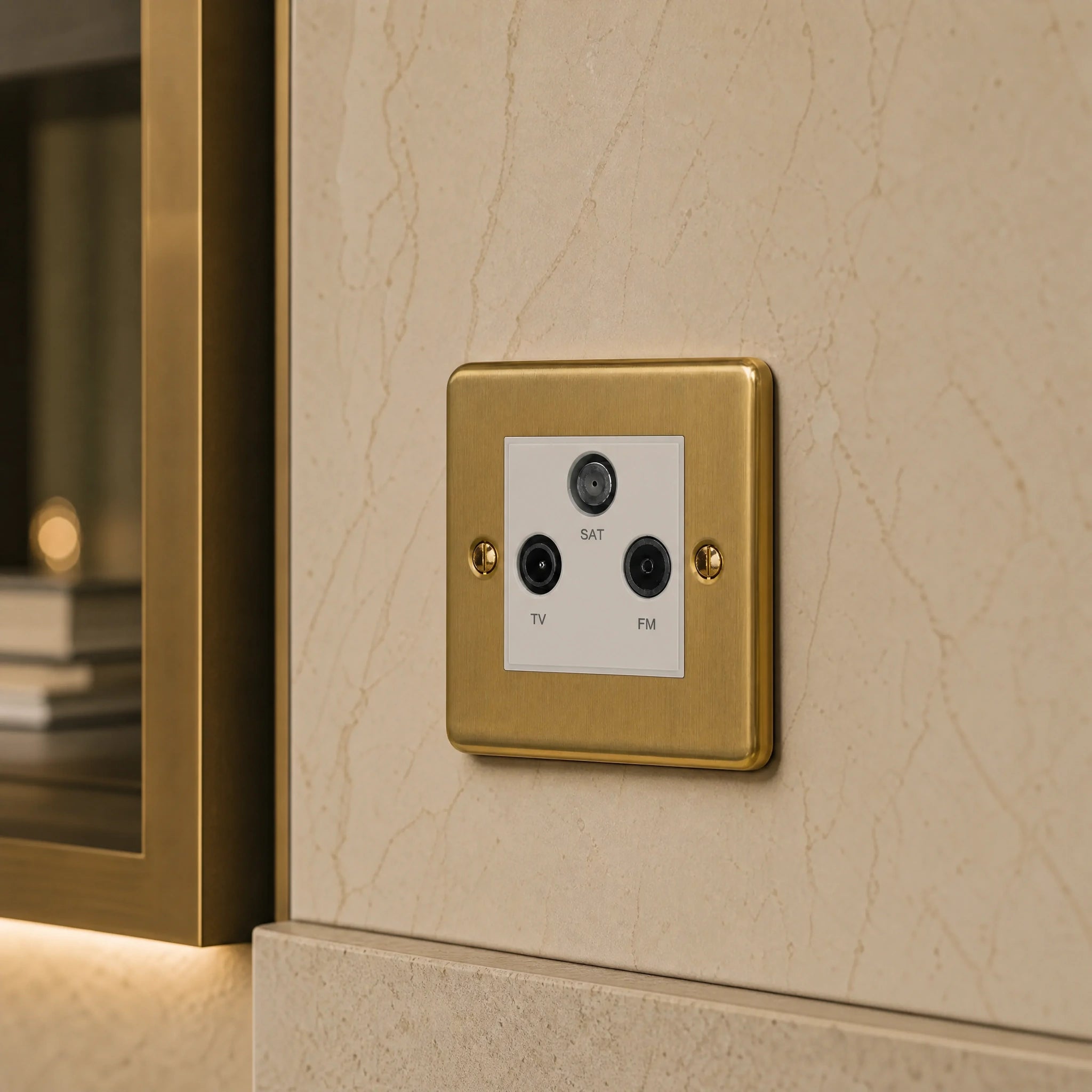 Close-up of a luxury antique brass media outlet installed within bespoke media wall or integrated TV joinery in a private residence by VORELLI®.