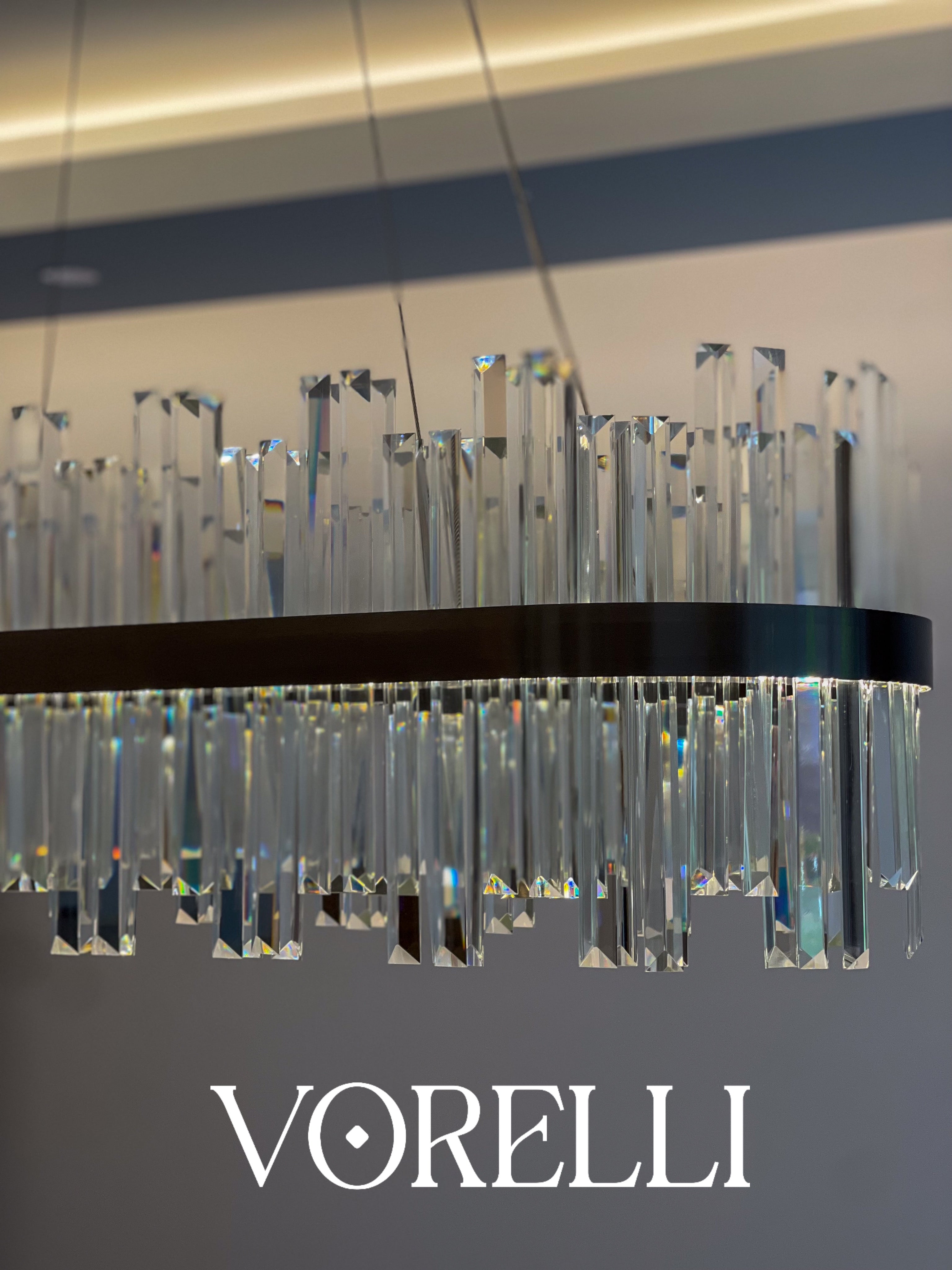 Close-up of crystal bars protruding from the circular frame of the VORELLI Medina chandelier forming a radiant halo of light