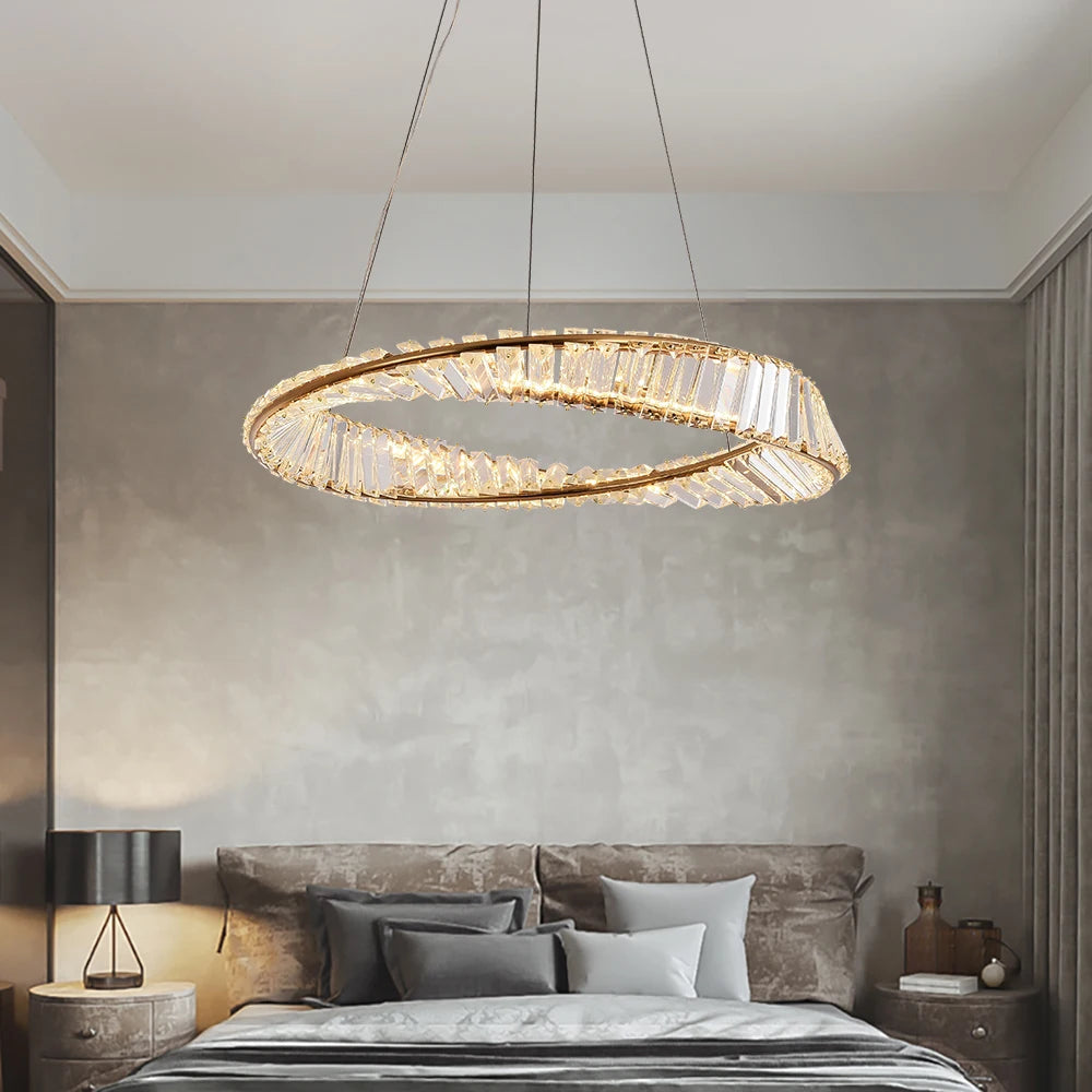 VORELLI Melia circular chandelier with twisted crystal bar ring design suspended above a modern luxury bedroom