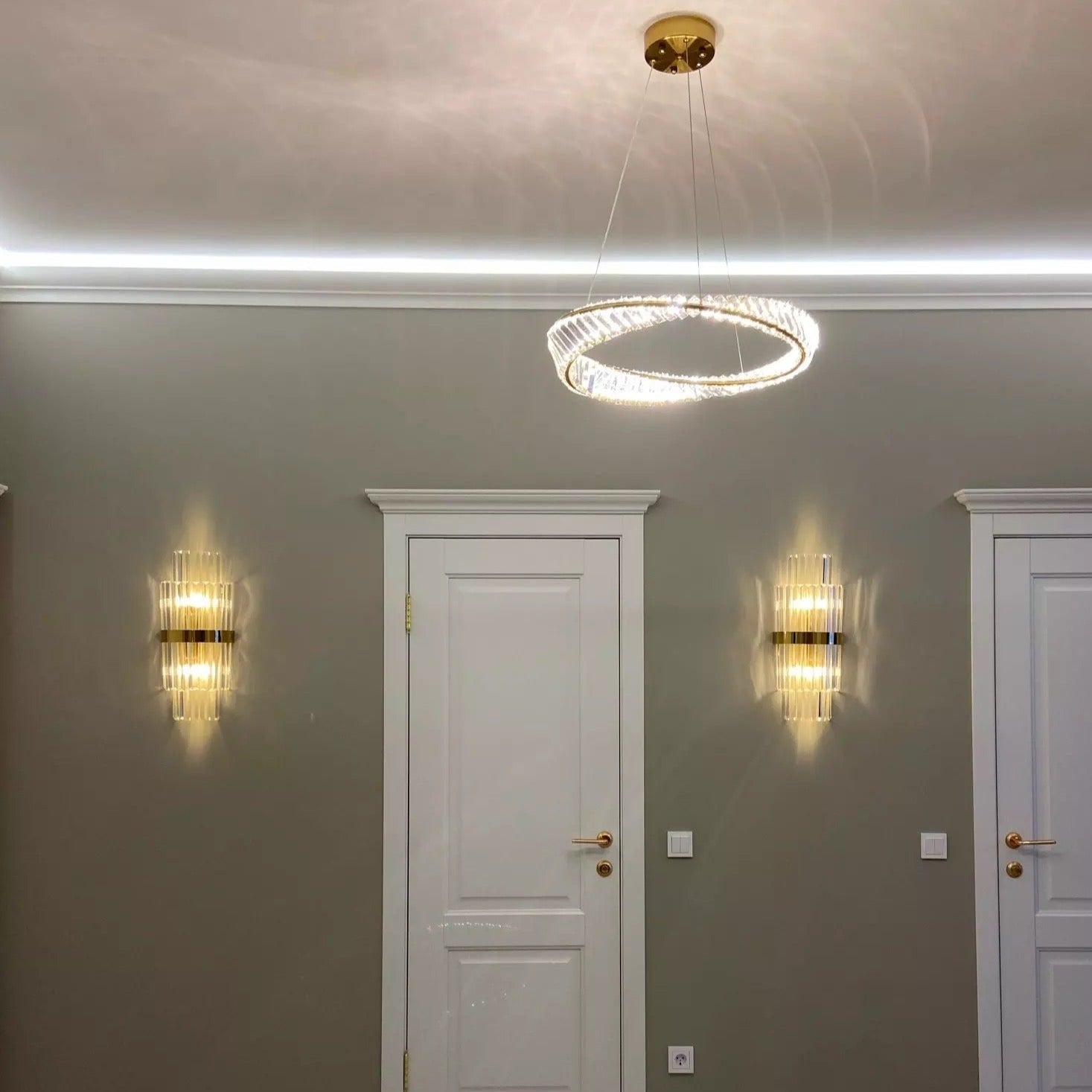 VORELLI Melia circular chandelier providing refined ambient lighting in a luxury hallway interior