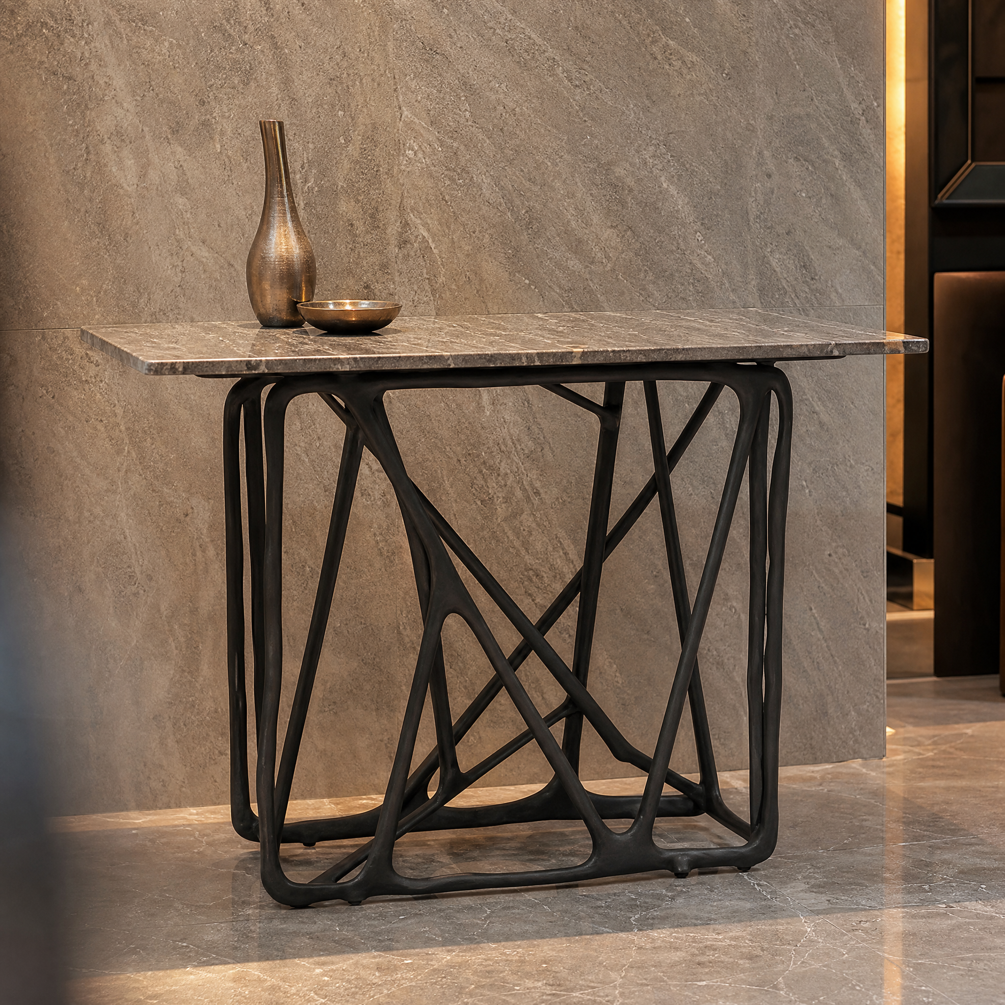 Detailed closeup of the warm grey marble top and bold architectural base of the VORELLI Merano console table.