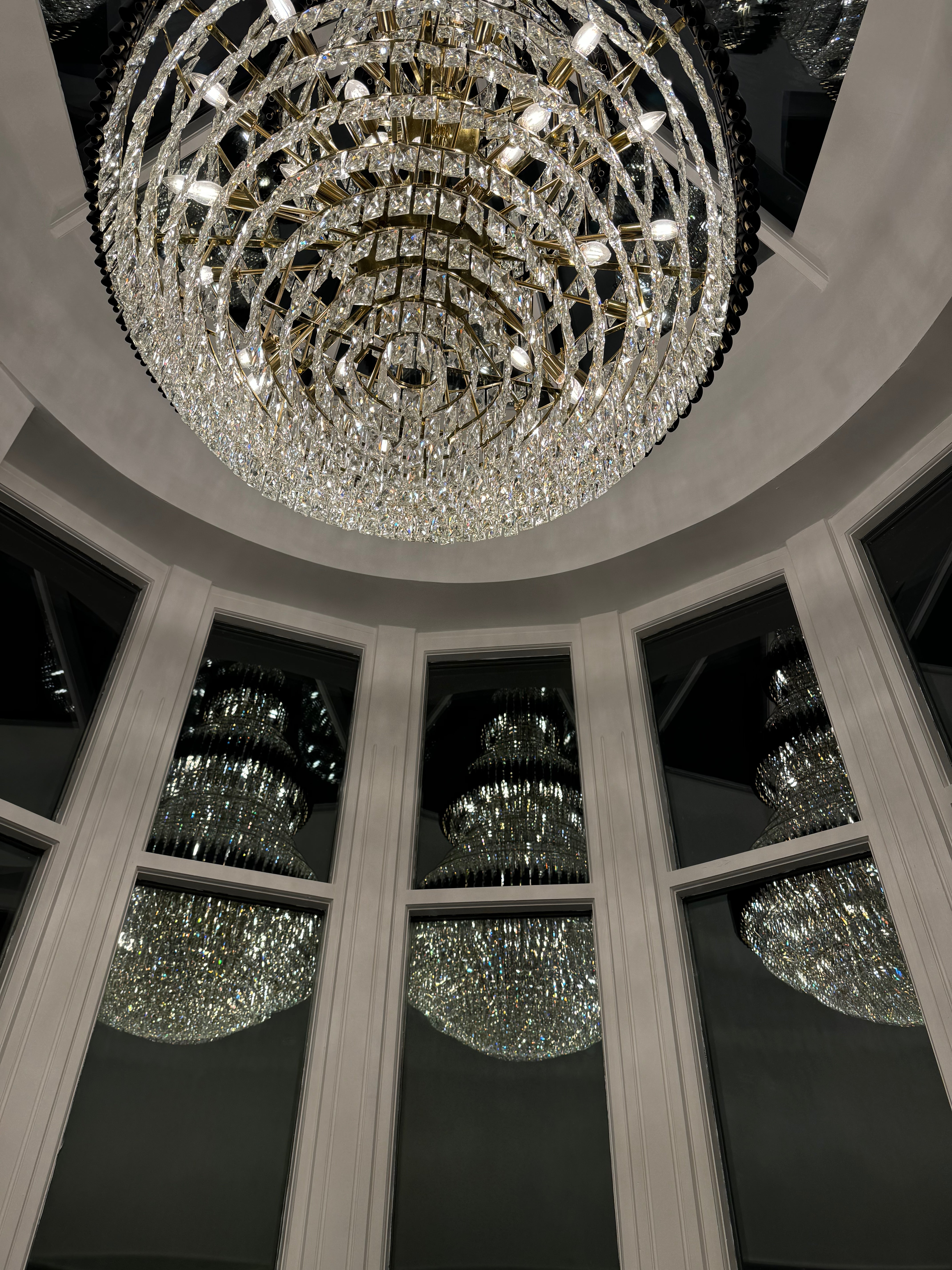 VORELLI Milltimber Grandeur Staircase Chandelier II installed beneath a domed architectural ceiling
