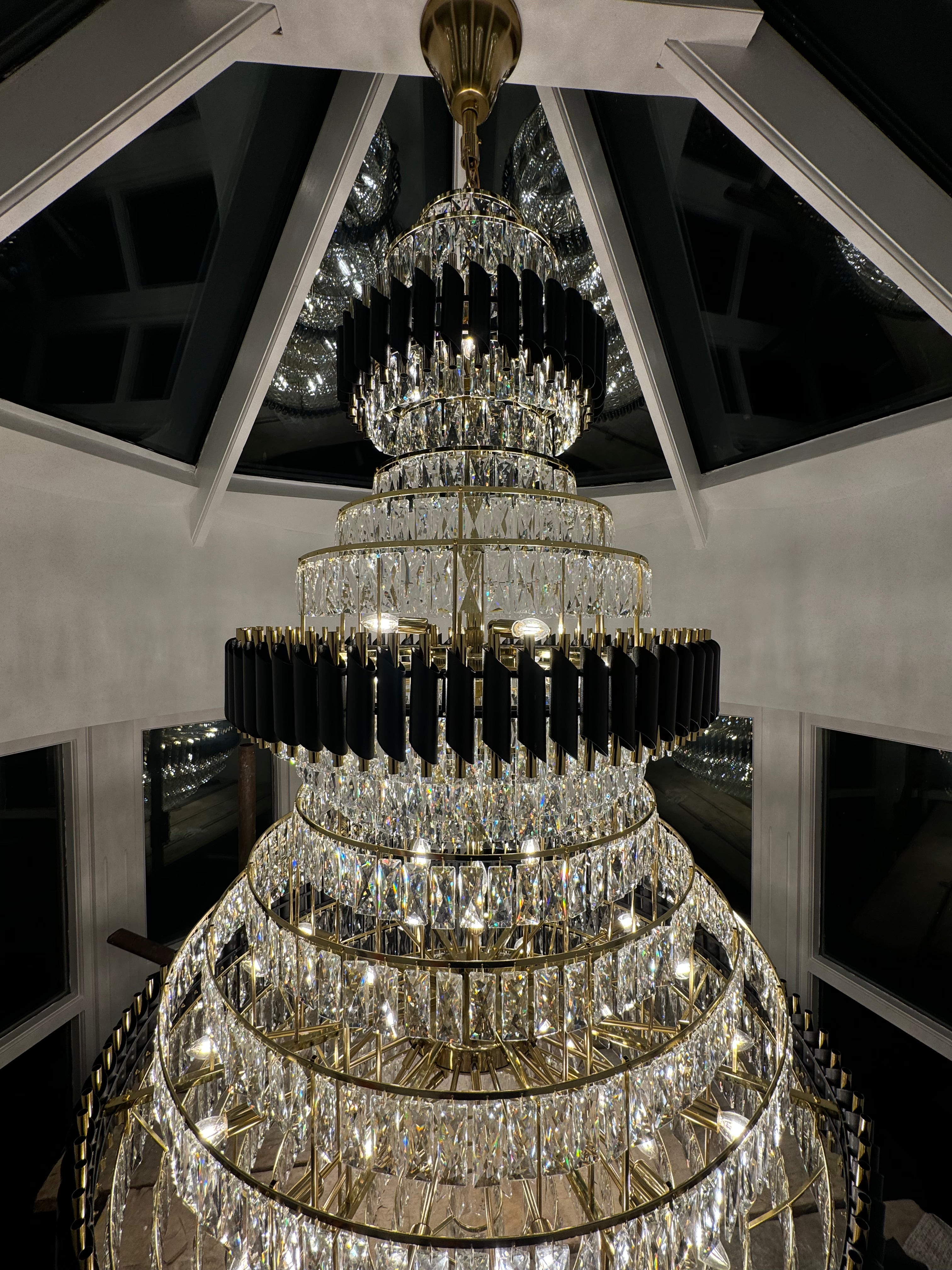 Three-tier cascading crystal structure of the VORELLI Milltimber Grandeur Staircase Chandelier II