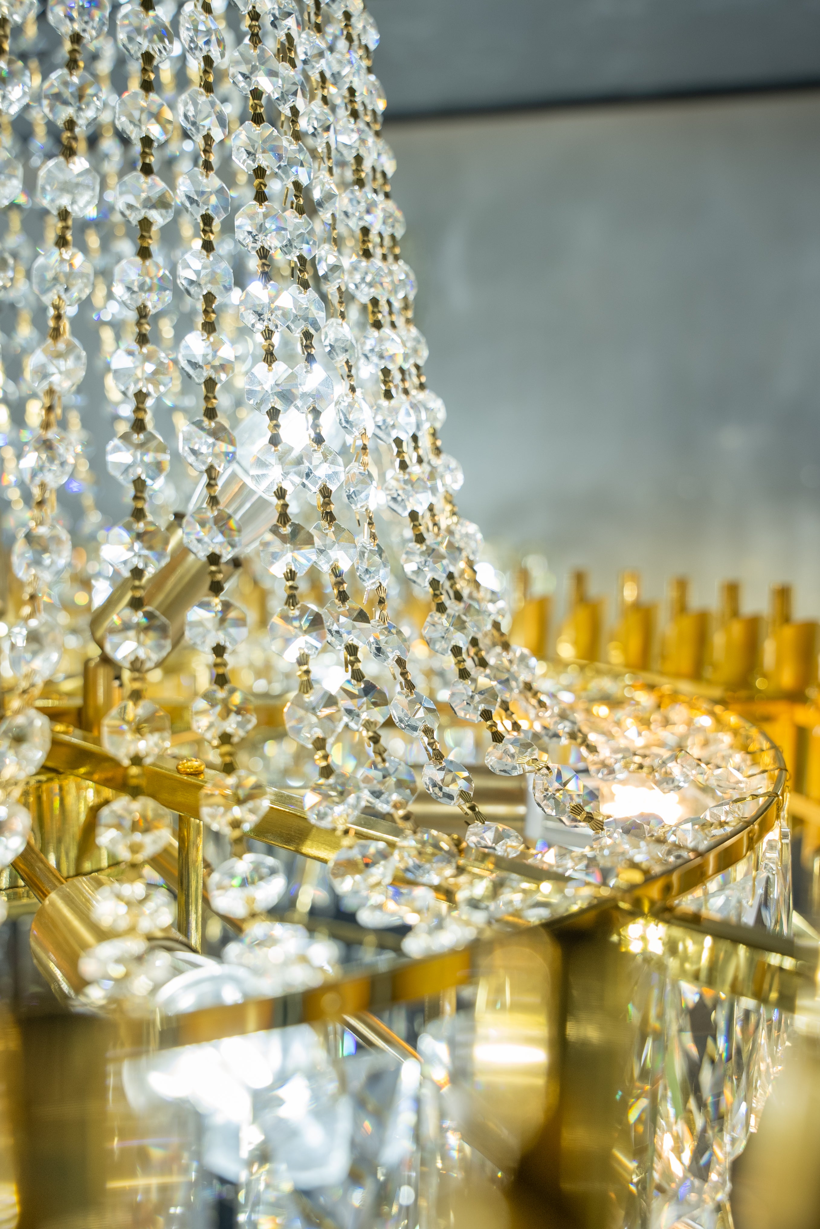 Gold structural frame with cascading crystals on the VORELLI Milltimber Grandeur staircase chandelier