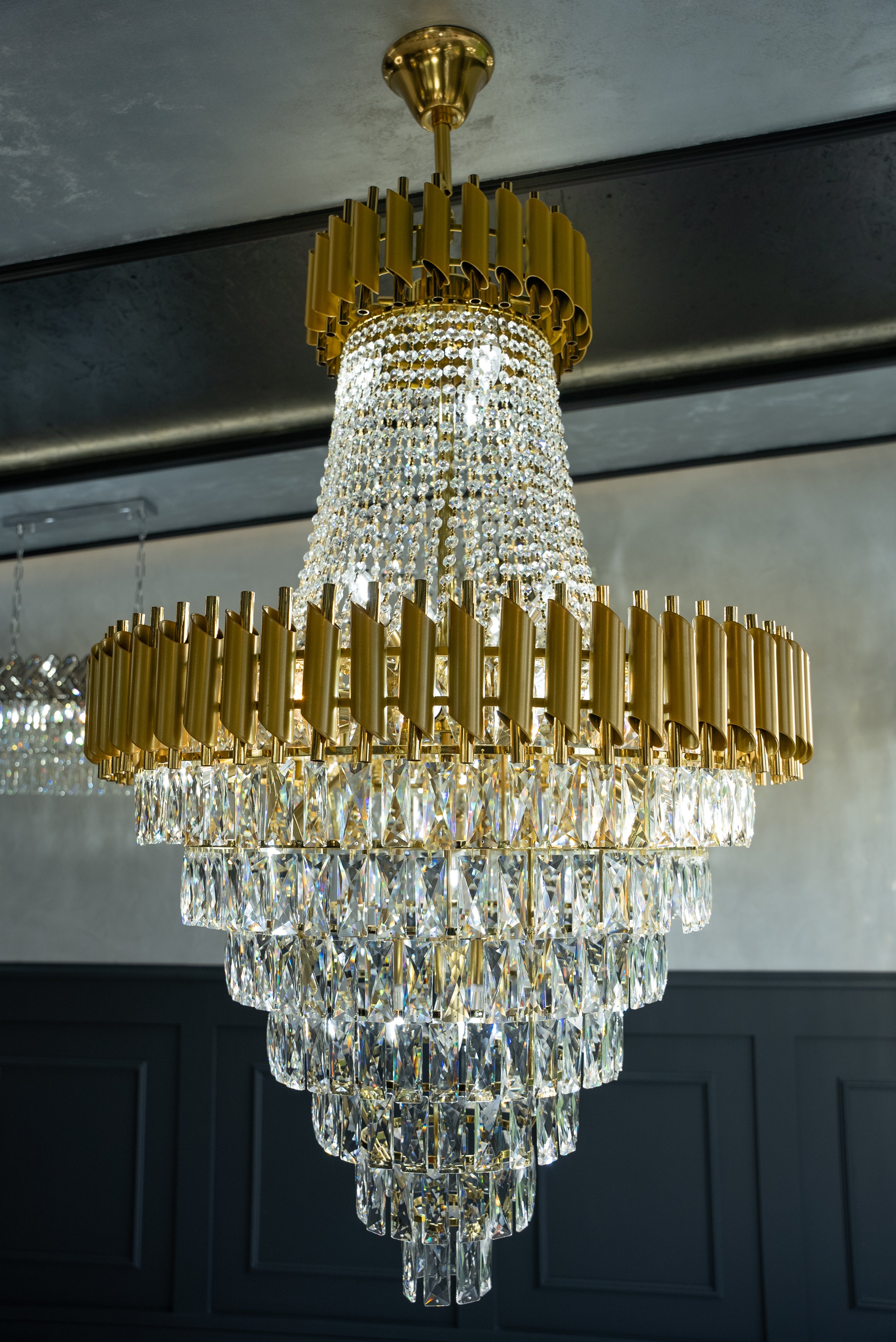 Side view of cascading diamond-cut crystal tiers on the VORELLI Milltimber Grandeur staircase chandelier