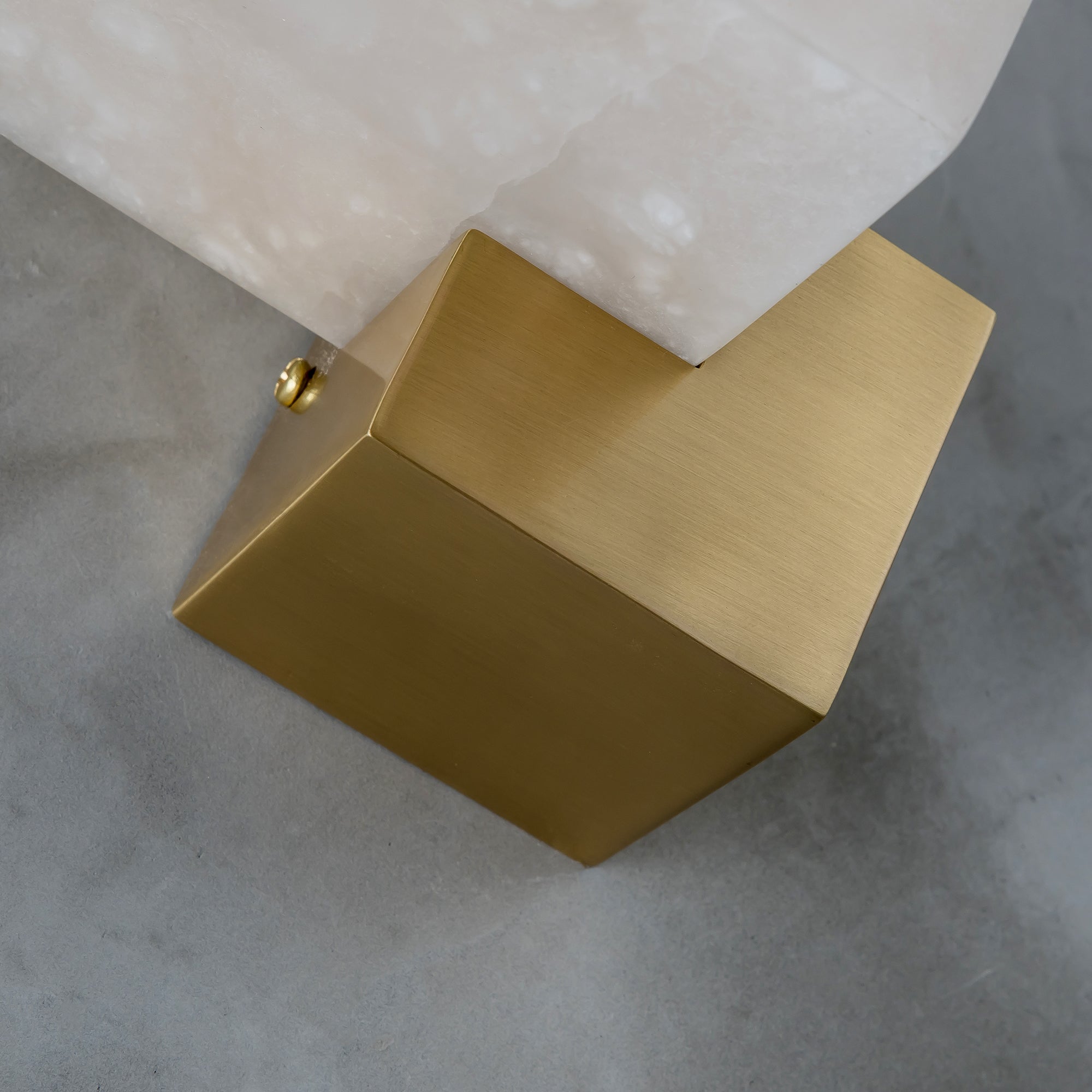 Close up of VORELLI® Modena marble wall light highlighting geometric alabaster form and structured base