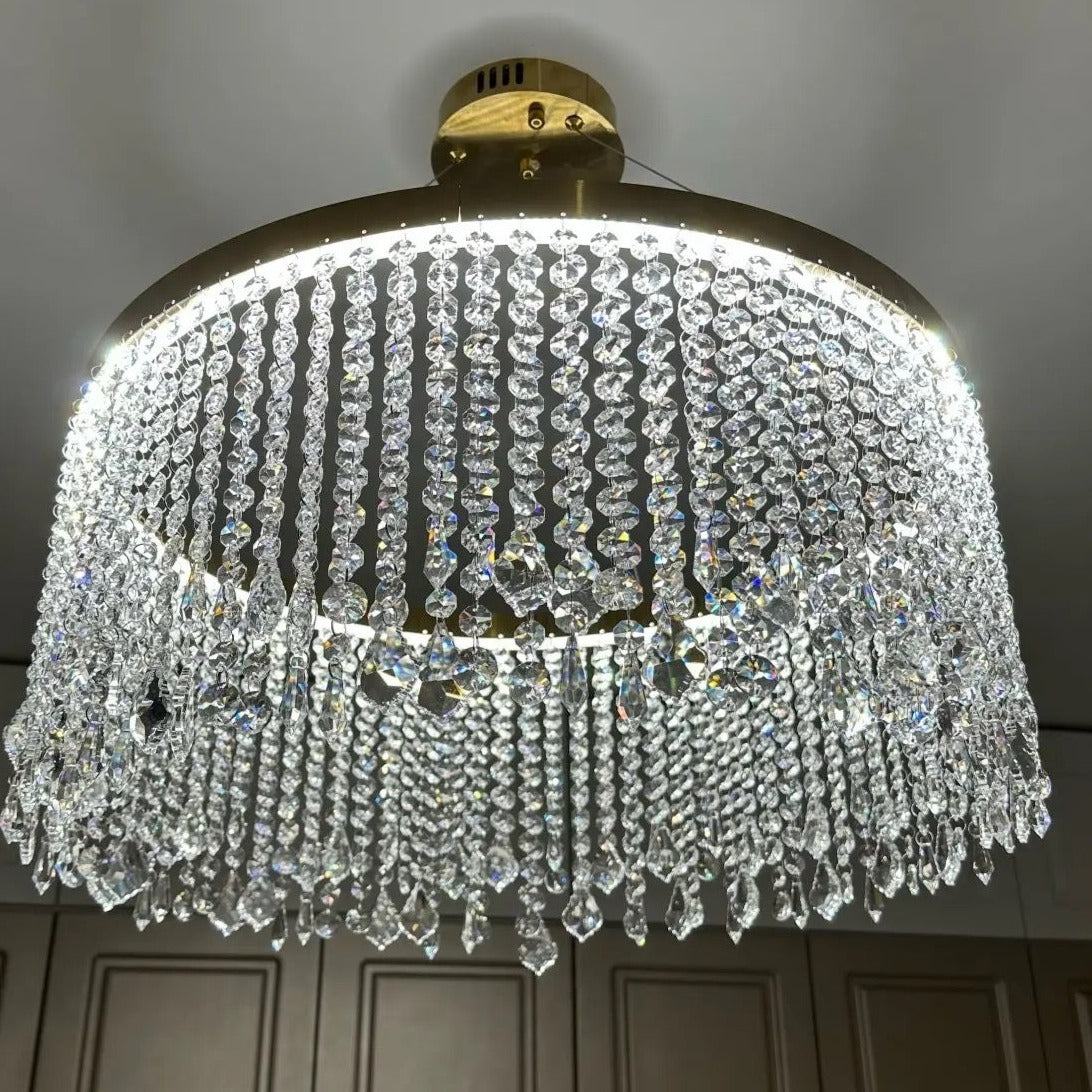 VORELLI® Modesto round crystal chandelier suspended in bedroom with layered diamond cut crystal chains