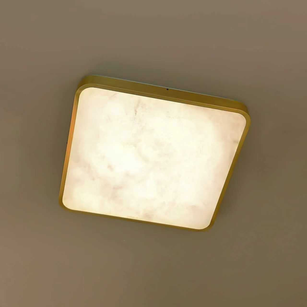 VORELLI® Morenita square marble ceiling light mounted to ceiling with soft illuminated stone surface