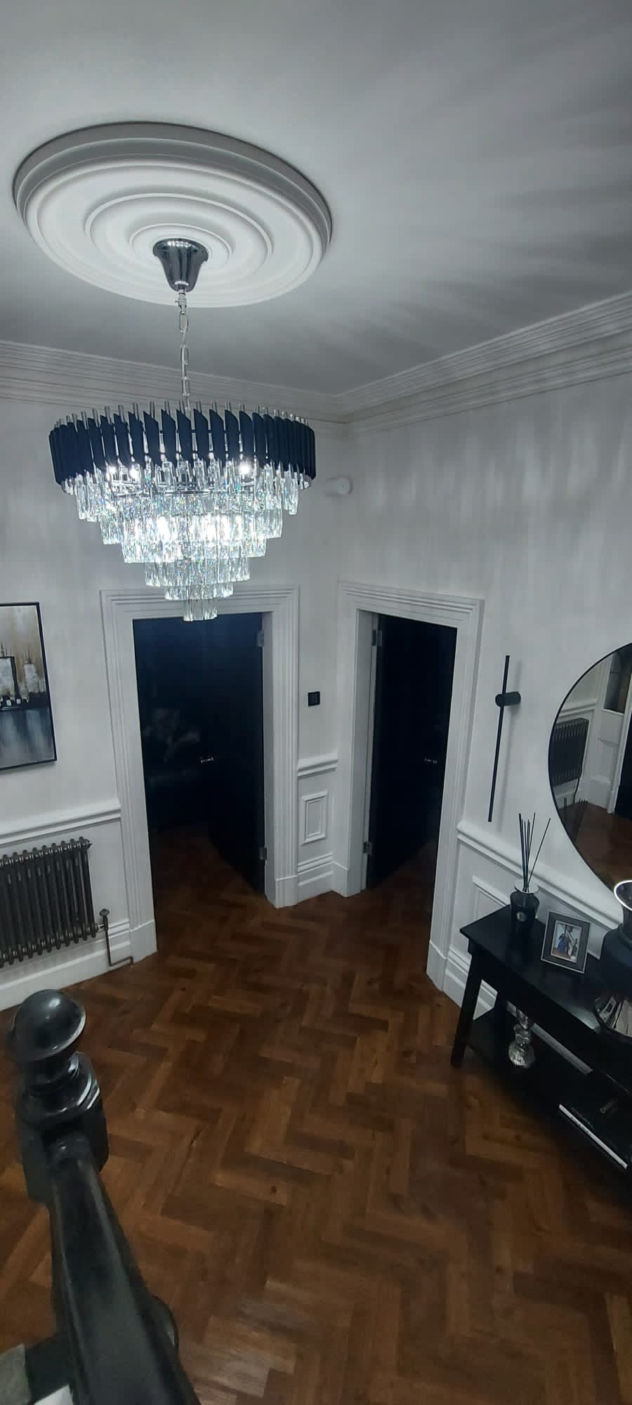 Multi-tier crystal chandelier by VORELLI® installed in a grand residential interior showcasing full drop and scale