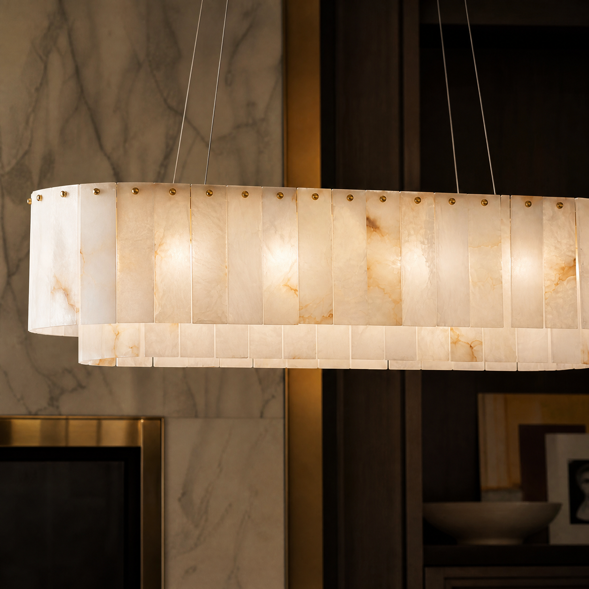 Detailed closeup of the VORELLI Munro chandelier highlighting the exquisite texture of polished marble panels and precision brass detailing.