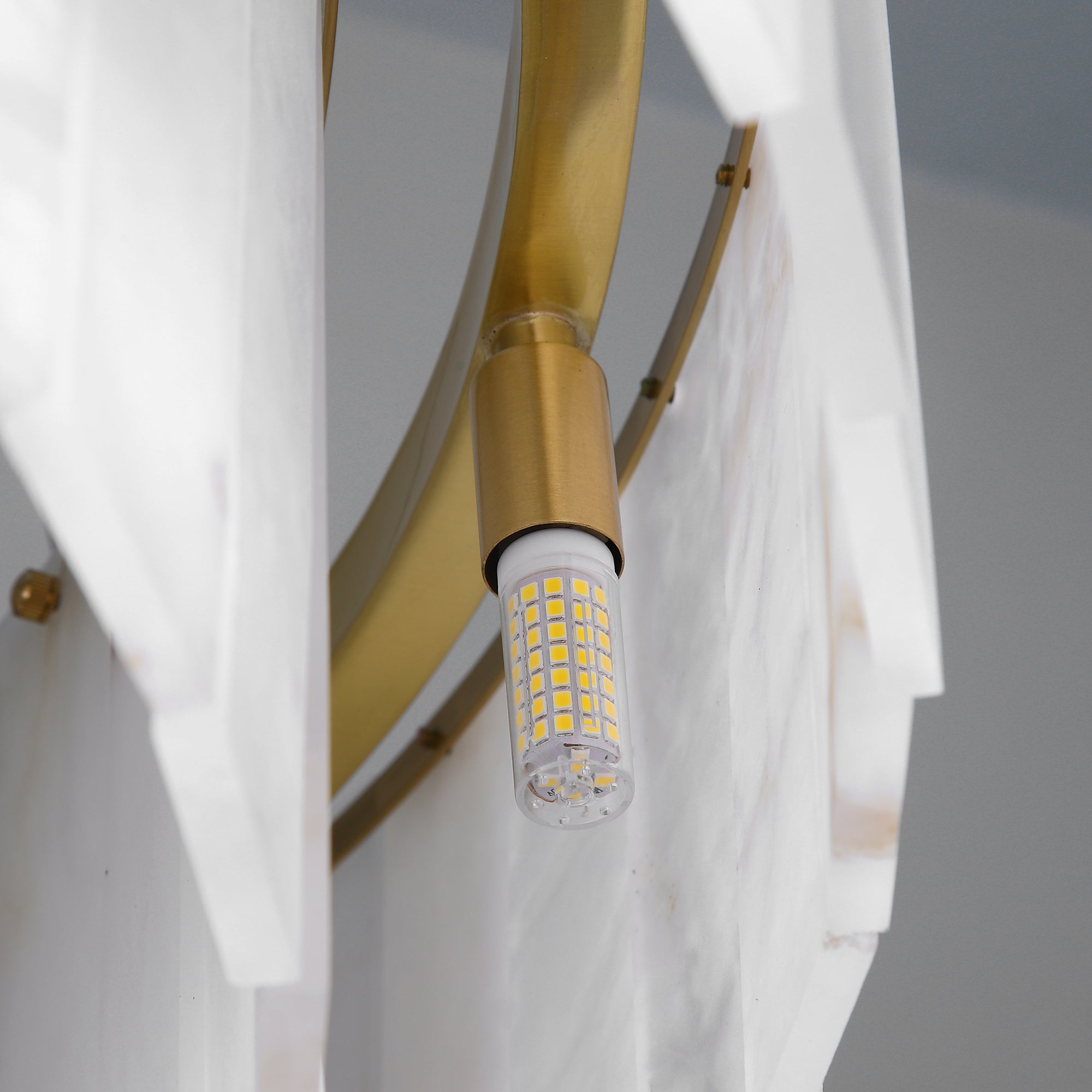 Close up of VORELLI® Munro marble rectangular chandelier showing precision stone panels and structured detailing